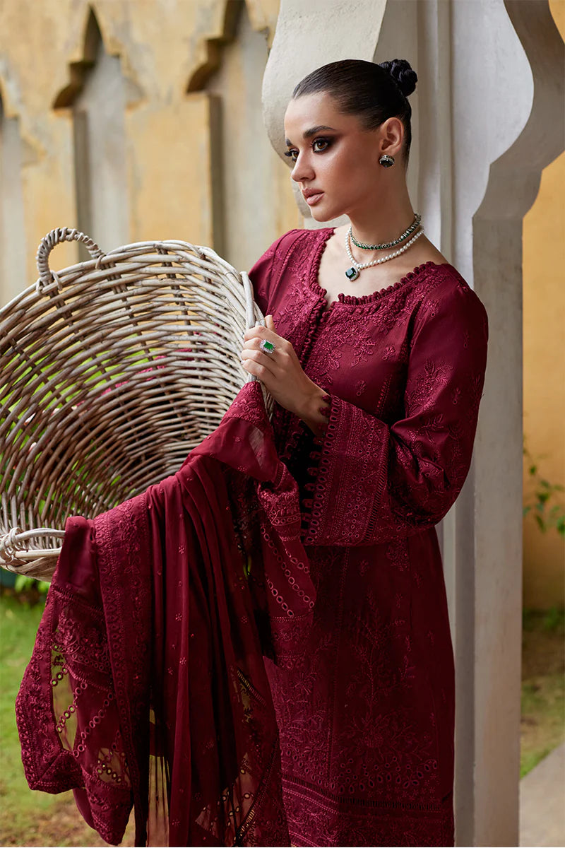 Model wearing Gulaal NIGELLA deep red luxury lawn dress with intricate embroidery. Shop Pakistani luxury pret online in the UK for an elegant look.