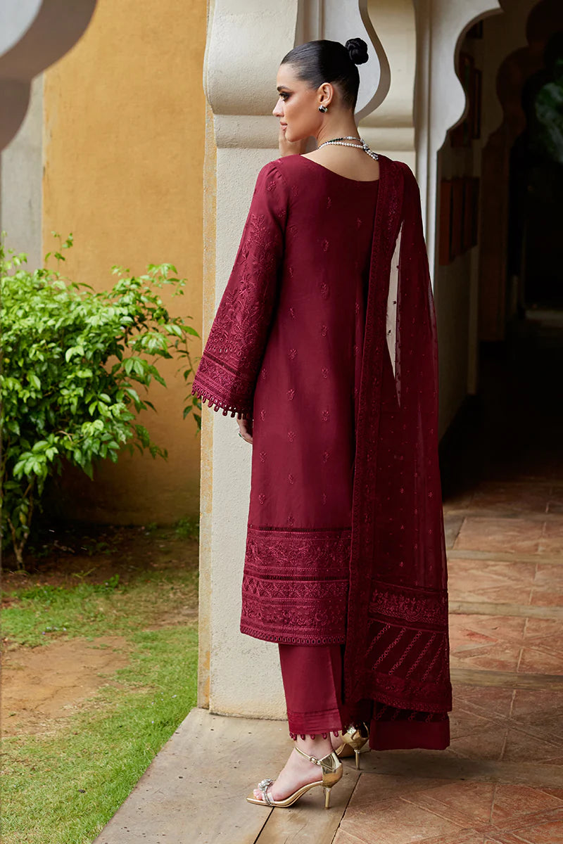 Model wearing Gulaal NIGELLA deep red luxury lawn dress with intricate embroidery. Shop Pakistani luxury pret online in the UK for an elegant look.