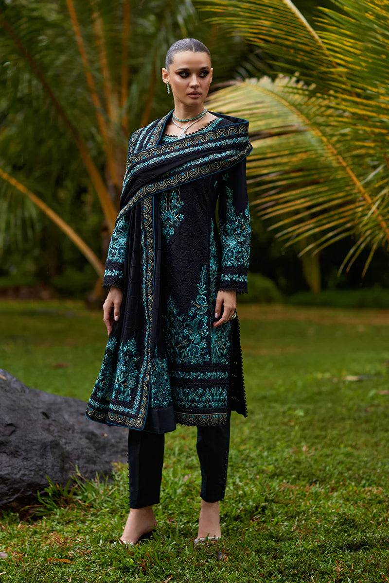 Model wearing Gulaal SCILLA black luxury lawn dress with intricate teal embroidery. Shop Pakistani luxury pret online in the UK for a timeless look.