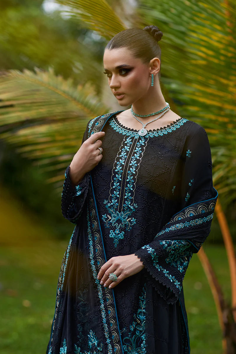 Model wearing Gulaal SCILLA black luxury lawn dress with intricate teal embroidery. Shop Pakistani luxury pret online in the UK for a timeless look.