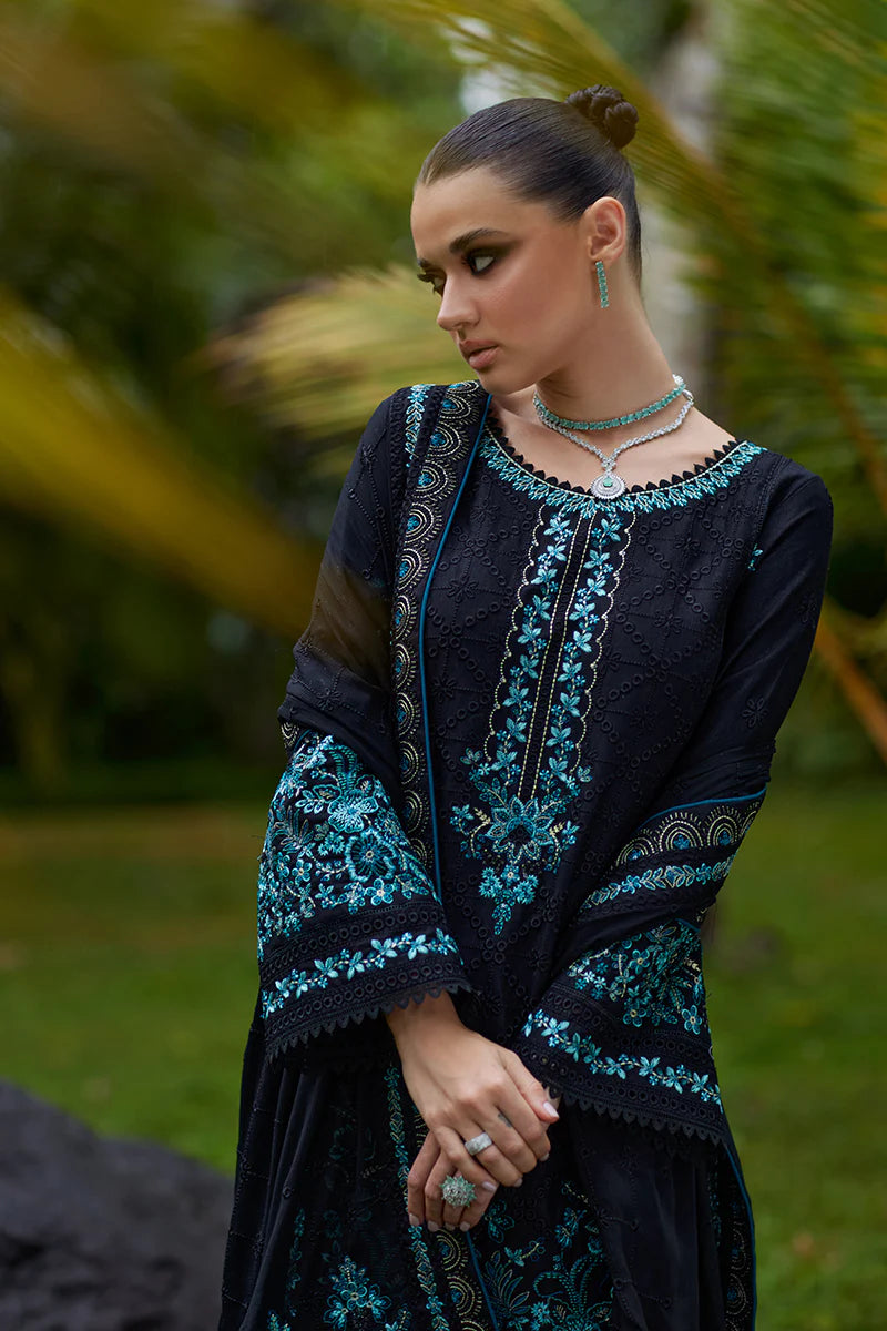 Model wearing Gulaal SCILLA black luxury lawn dress with intricate teal embroidery. Shop Pakistani luxury pret online in the UK for a timeless look.