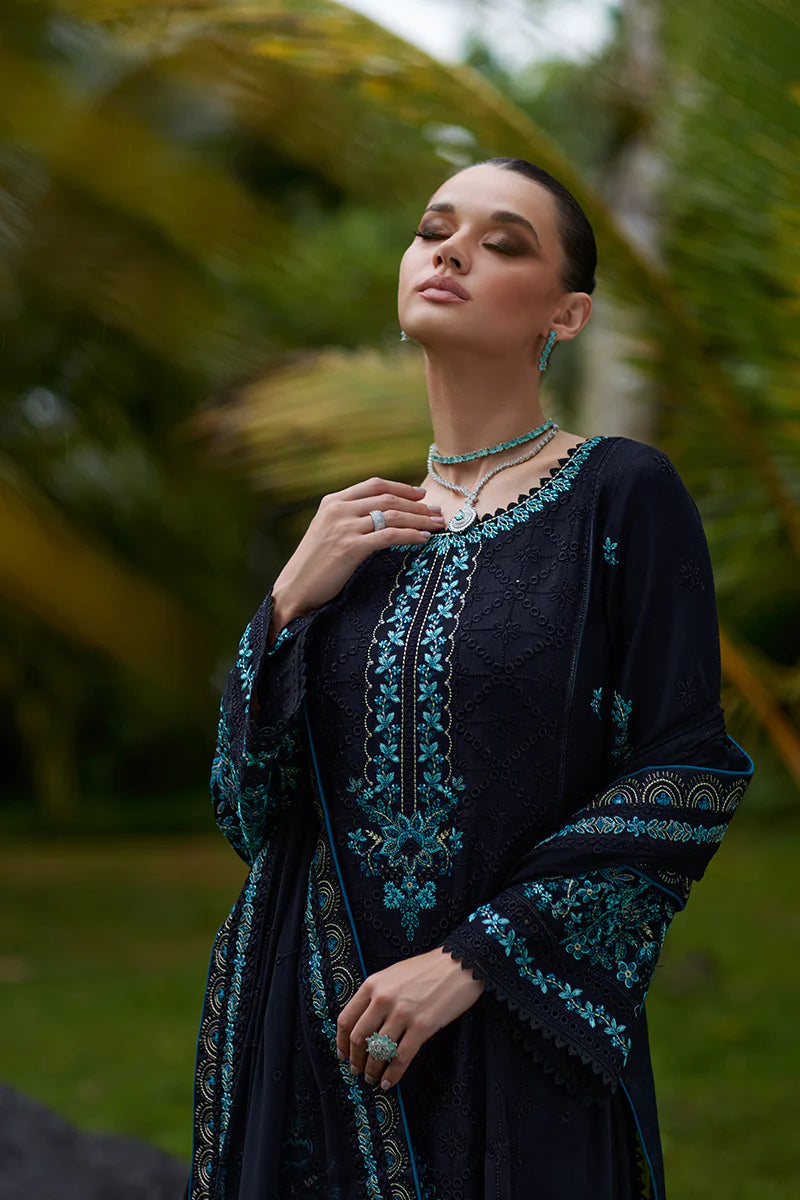 Model wearing Gulaal SCILLA black luxury lawn dress with intricate teal embroidery. Shop Pakistani luxury pret online in the UK for a timeless look.