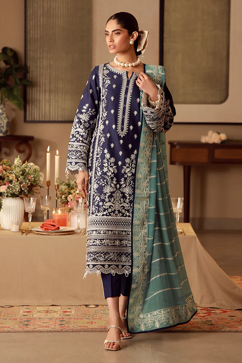Model wearing navy blue Gulaal Ziya outfit with intricate white embroidery and green dupatta, perfect for Pakistani luxury pret in the UK.
