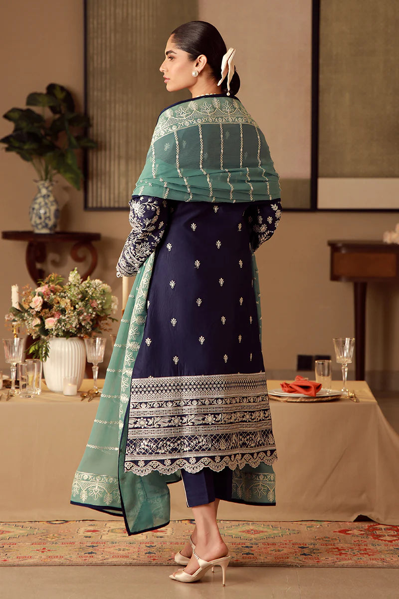 Model wearing navy blue Gulaal Ziya outfit with intricate white embroidery and green dupatta, perfect for Pakistani luxury pret in the UK.
