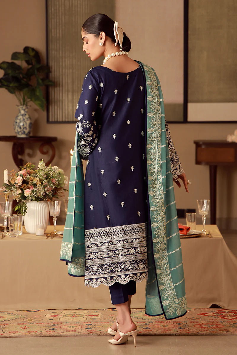 Model wearing navy blue Gulaal Ziya outfit with intricate white embroidery and green dupatta, perfect for Pakistani luxury pret in the UK.
