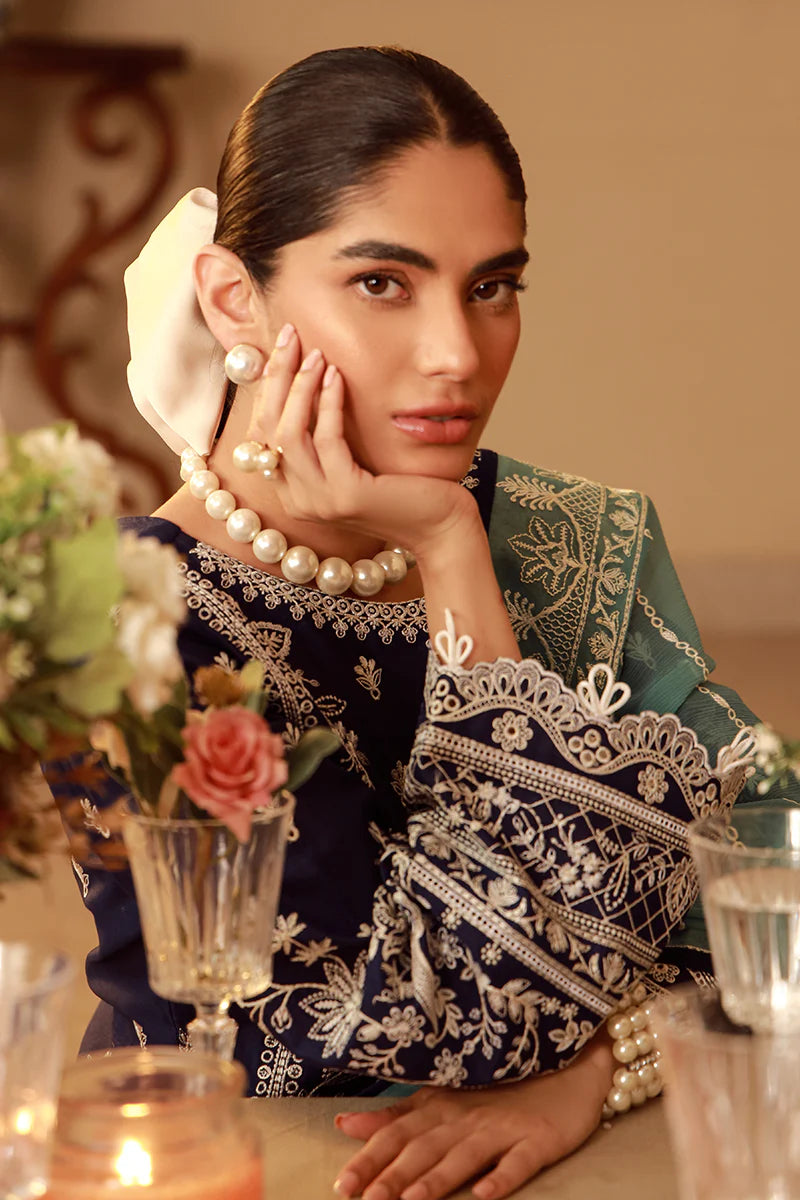 Model wearing navy blue Gulaal Ziya outfit with intricate white embroidery and green dupatta, perfect for Pakistani luxury pret in the UK.
