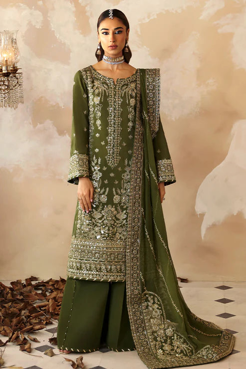 Model wearing an olive-green Gulaal Shehrnaaz Raw Silk outfit, embellished with intricate embroidery and sequins on the front, sleeves, and back. The look is completed with a fully embroidered chiffon dupatta and dyed silk trousers, ideal for festive occasions.