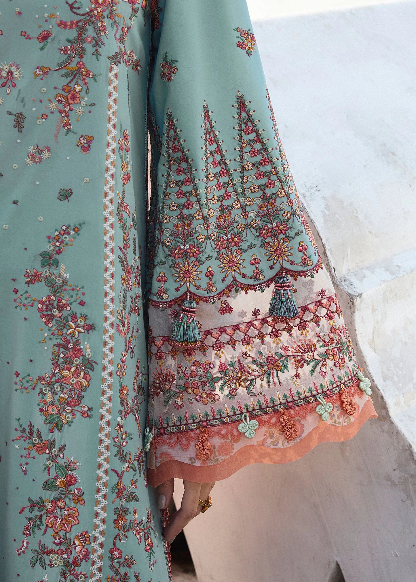 Model wearing Hussain Rehar Luxury Lawn '25 Malibu in turquoise blue with peach dupatta, intricate embroidery. Shop Pakistani luxury pret online in the UK.