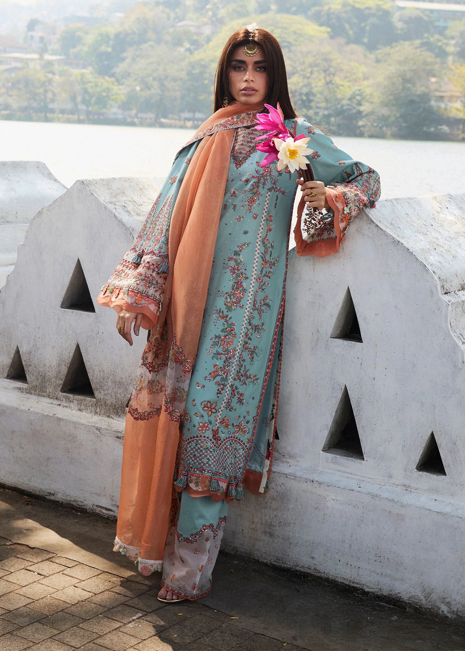 Model wearing Hussain Rehar Luxury Lawn '25 Malibu in turquoise blue with peach dupatta, intricate embroidery. Shop Pakistani luxury pret online in the UK.