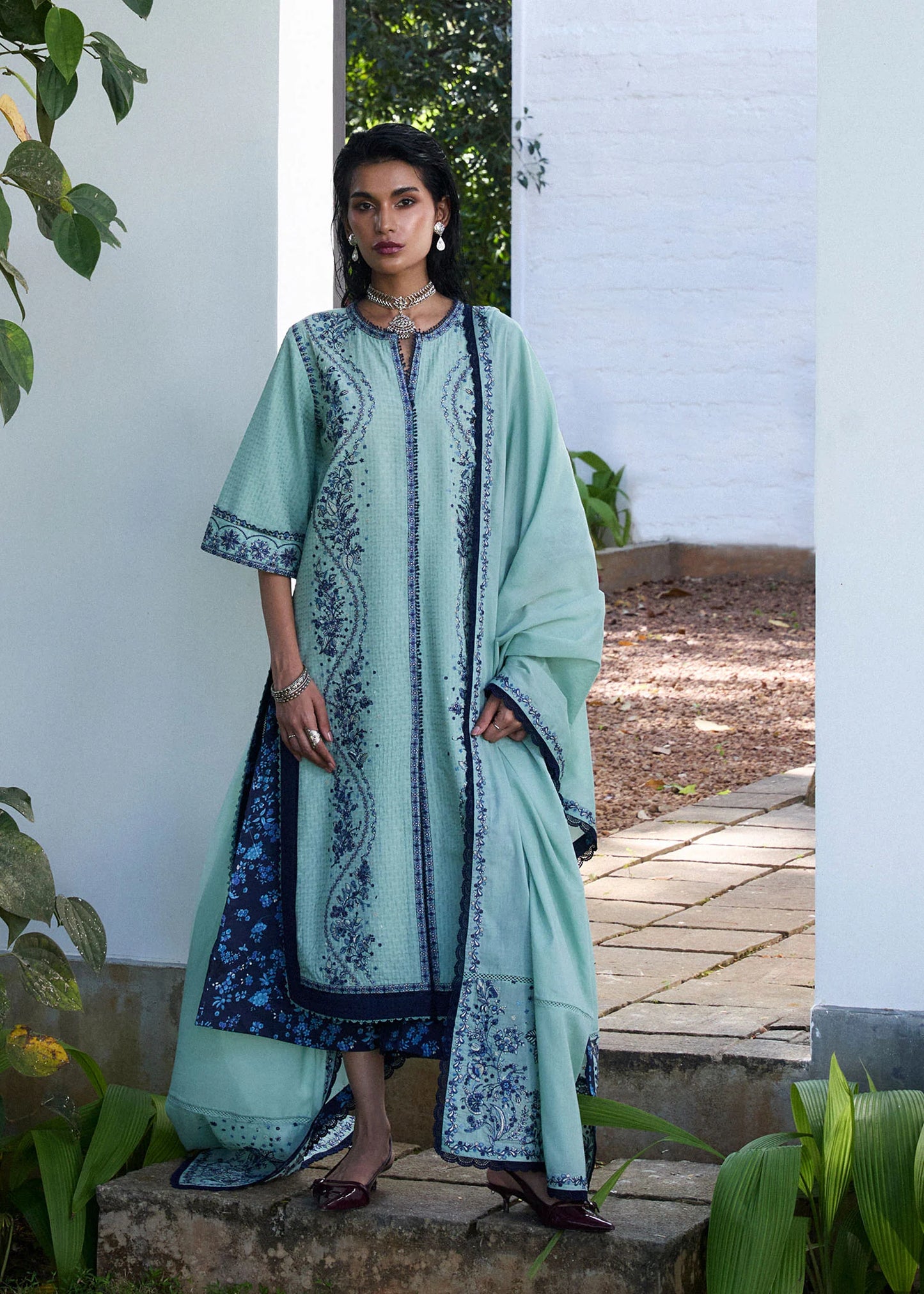Model wearing light turquoise and navy embroidered Nesta outfit from Hussain Rehar Pret SS '25, Pakistani luxury pret and clothes online in UK.
