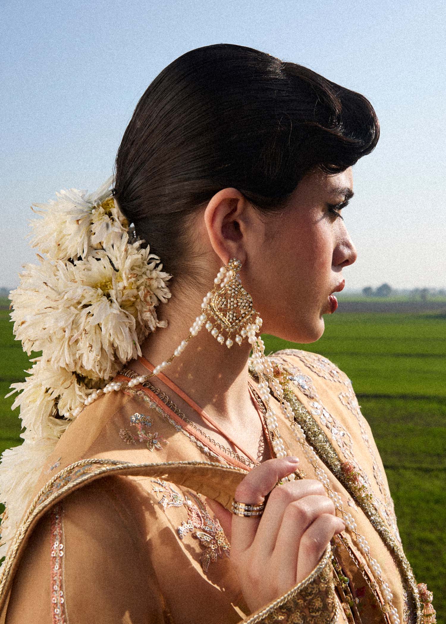 Model wearing Hussain Rehar Sundal golden beige embroidered festive dress with intricate embellishments and traditional details. Shop Pakistani clothes online in the UK now.