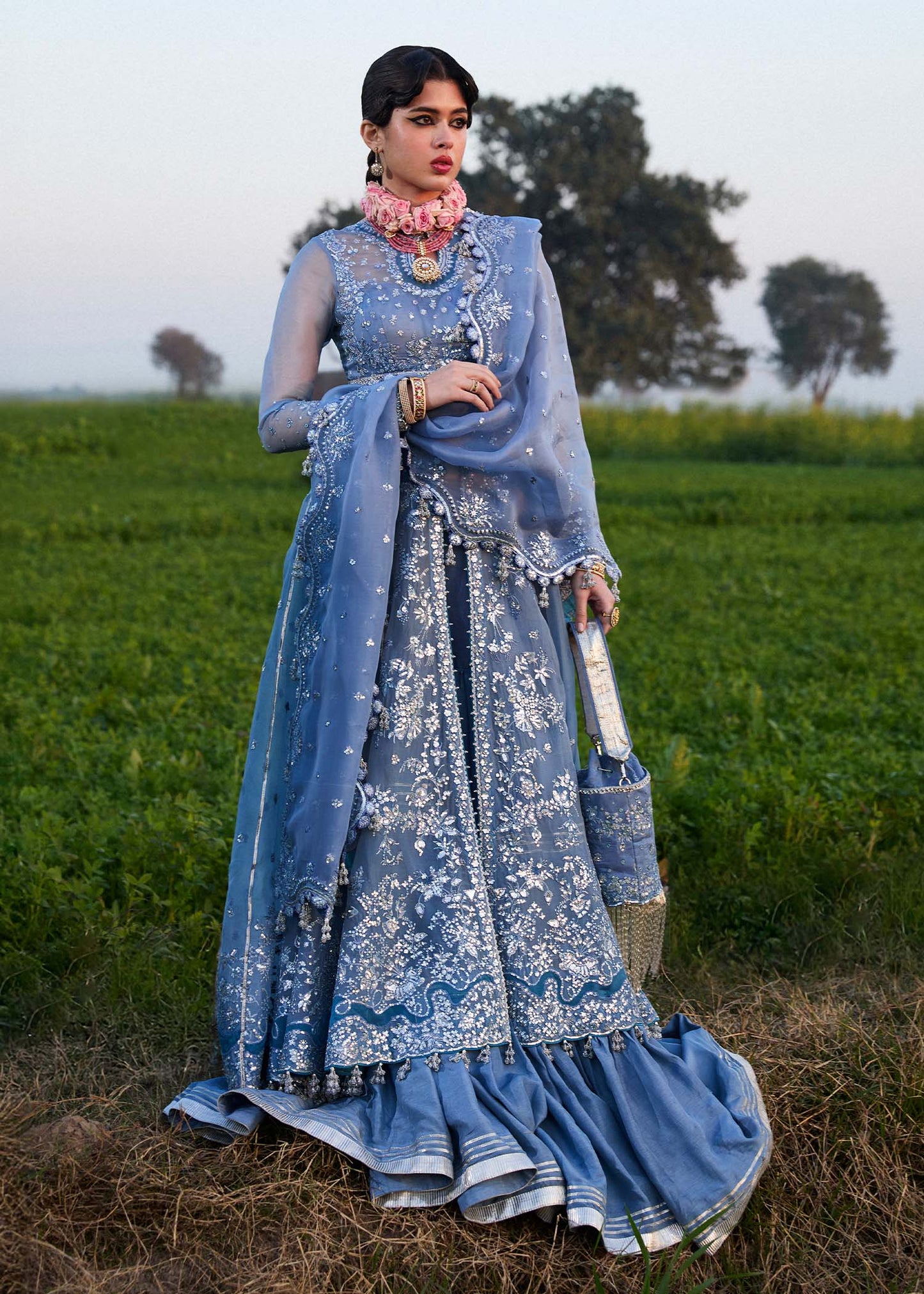 Model wearing Hussain Rehar Mira ice blue embroidered festive dress with intricate embellishments and elegant detailing. Shop Pakistani clothes online in the UK now.