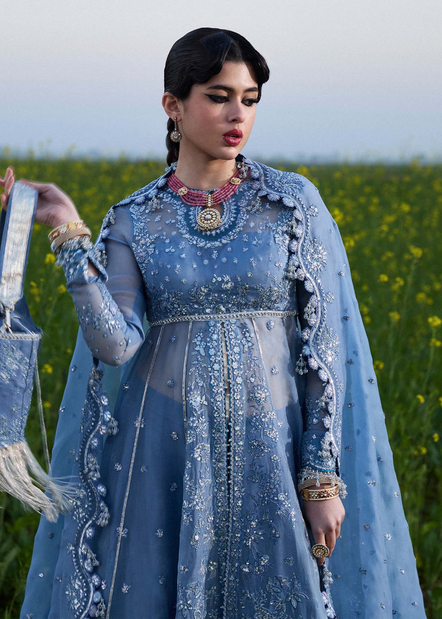 Model wearing Hussain Rehar Mira ice blue embroidered festive dress with intricate embellishments and elegant detailing. Shop Pakistani clothes online in the UK now.