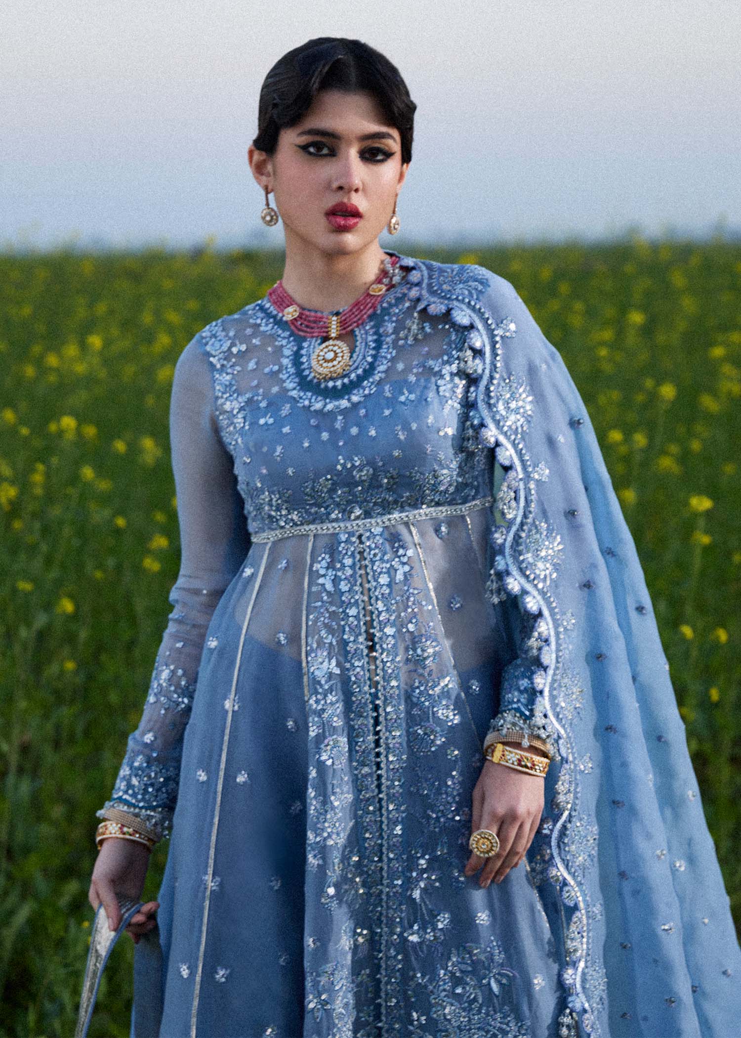 Model wearing Hussain Rehar Mira ice blue embroidered festive dress with intricate embellishments and elegant detailing. Shop Pakistani clothes online in the UK now.