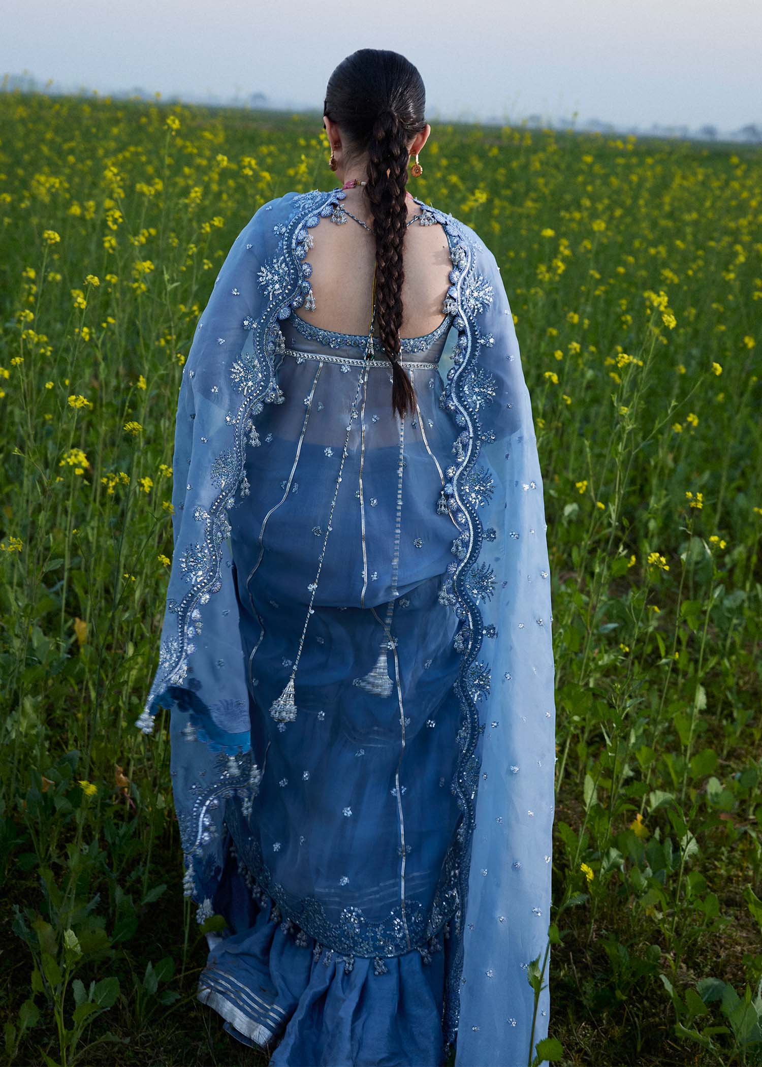 Model wearing Hussain Rehar Mira ice blue embroidered festive dress with intricate embellishments and elegant detailing. Shop Pakistani clothes online in the UK now.