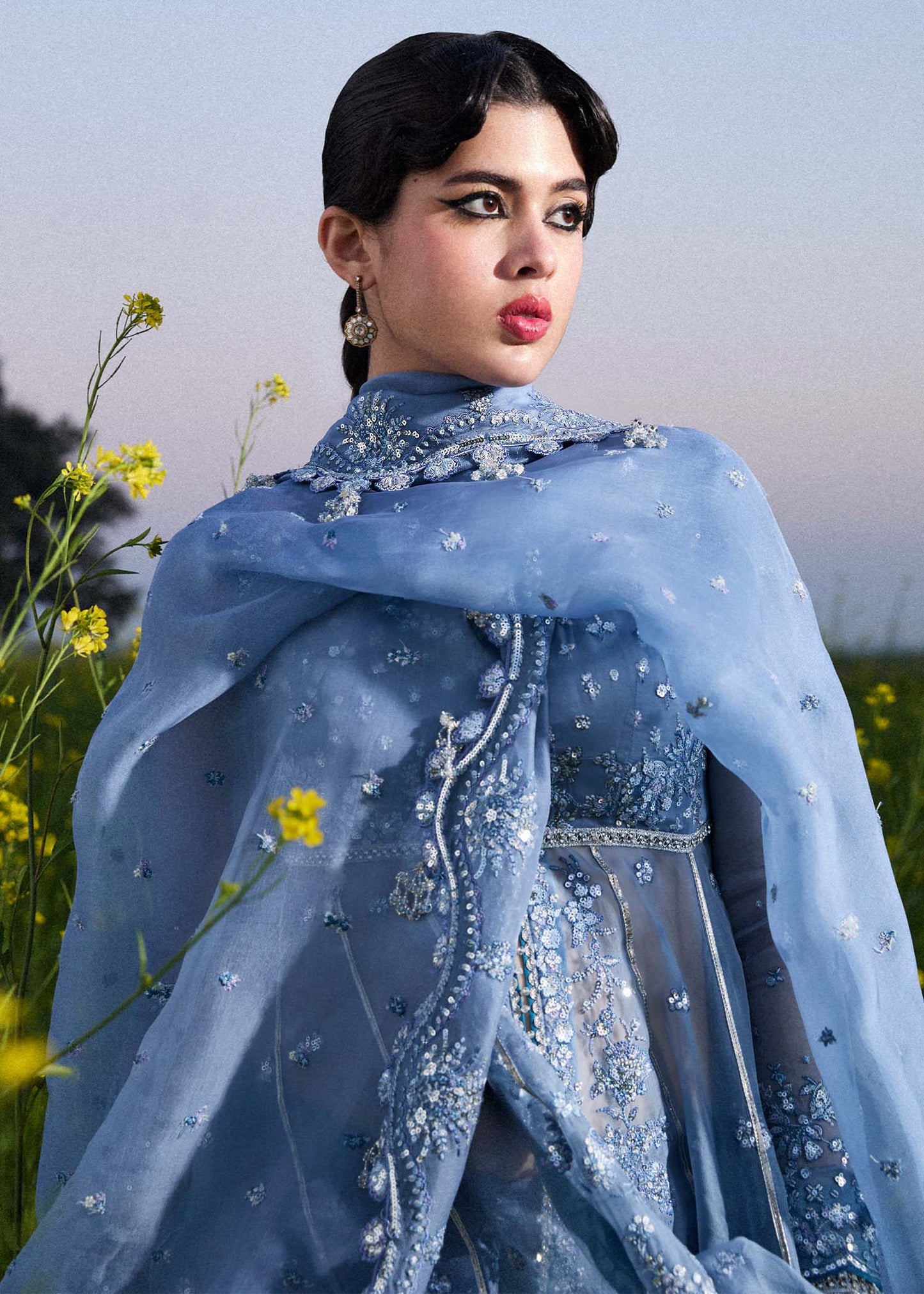 Model wearing Hussain Rehar Mira ice blue embroidered festive dress with intricate embellishments and elegant detailing. Shop Pakistani clothes online in the UK now.