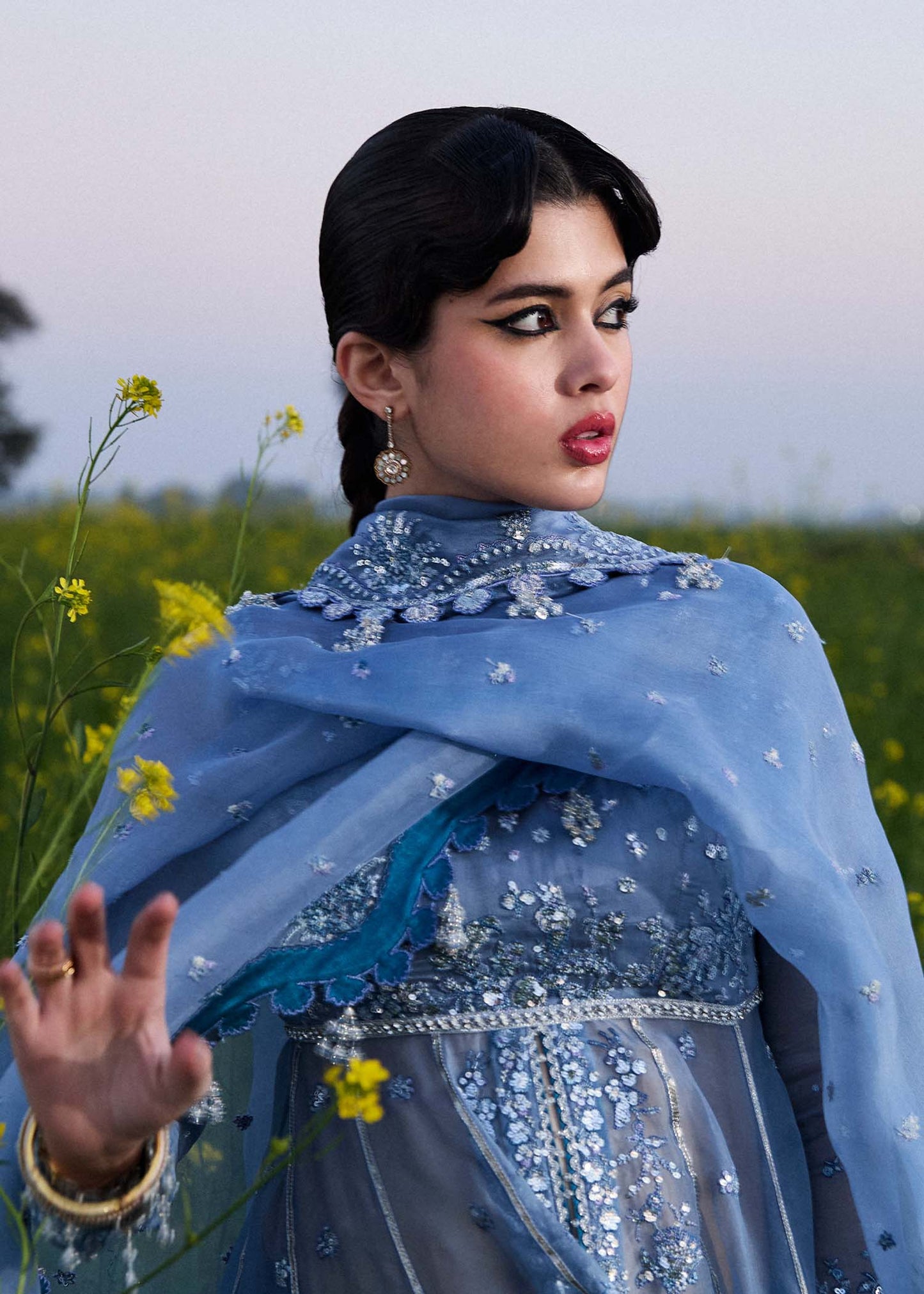 Model wearing Hussain Rehar Mira ice blue embroidered festive dress with intricate embellishments and elegant detailing. Shop Pakistani clothes online in the UK now.