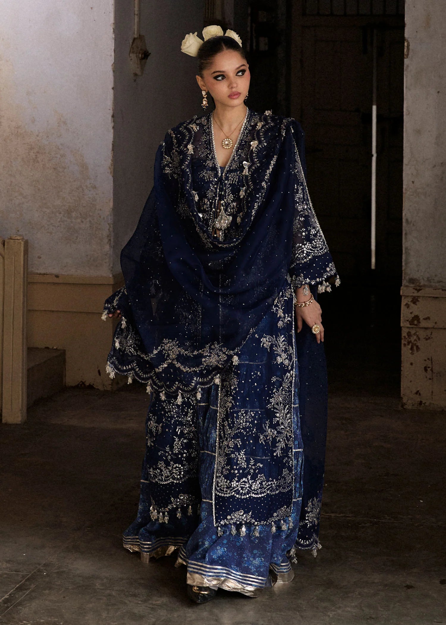 Model wearing Hussain Rehar Safa navy blue embroidered festive dress with intricate embellishments and sheer details. Shop Pakistani clothes online in the UK now.