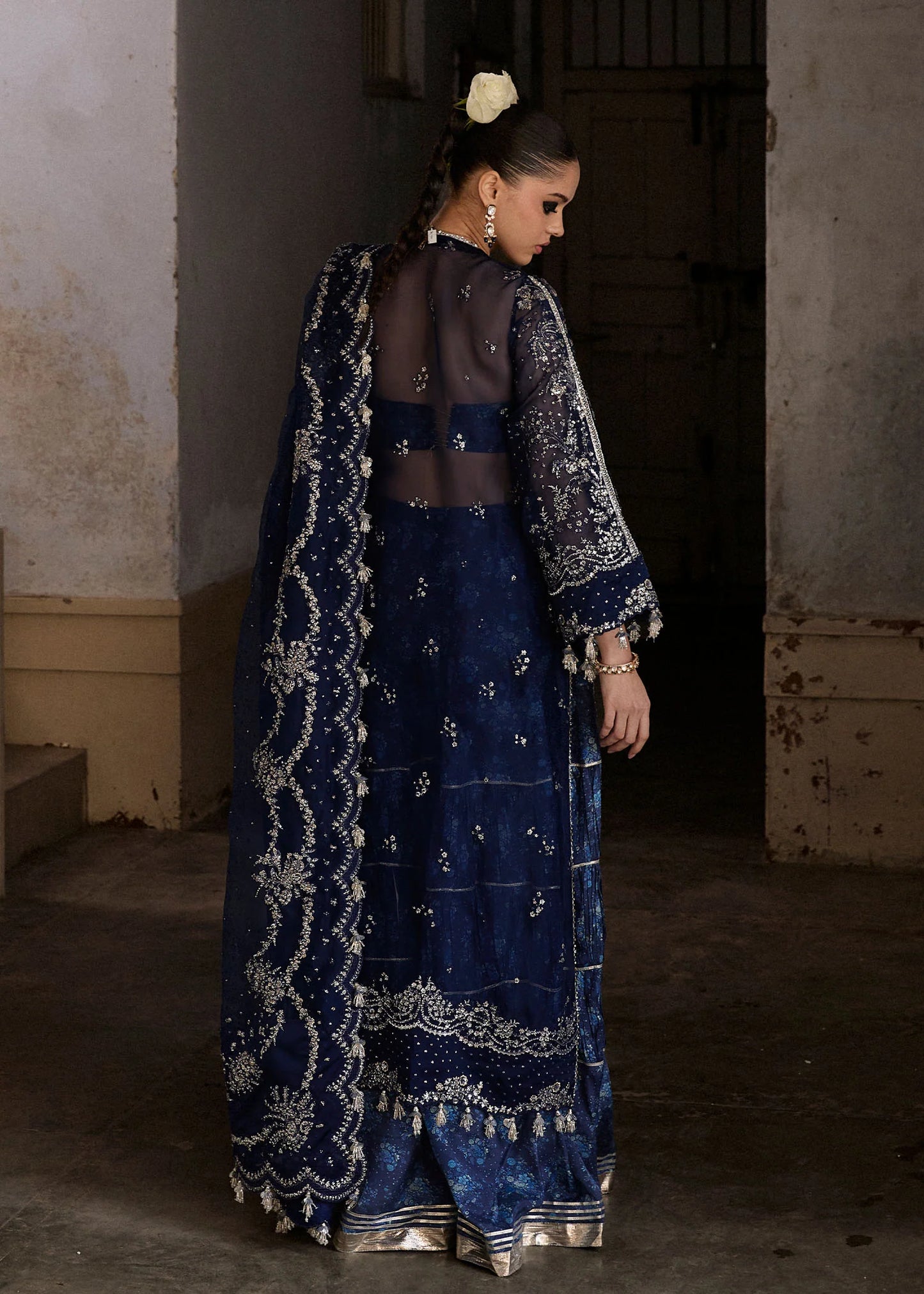 Model wearing Hussain Rehar Safa navy blue embroidered festive dress with intricate embellishments and sheer details. Shop Pakistani clothes online in the UK now.