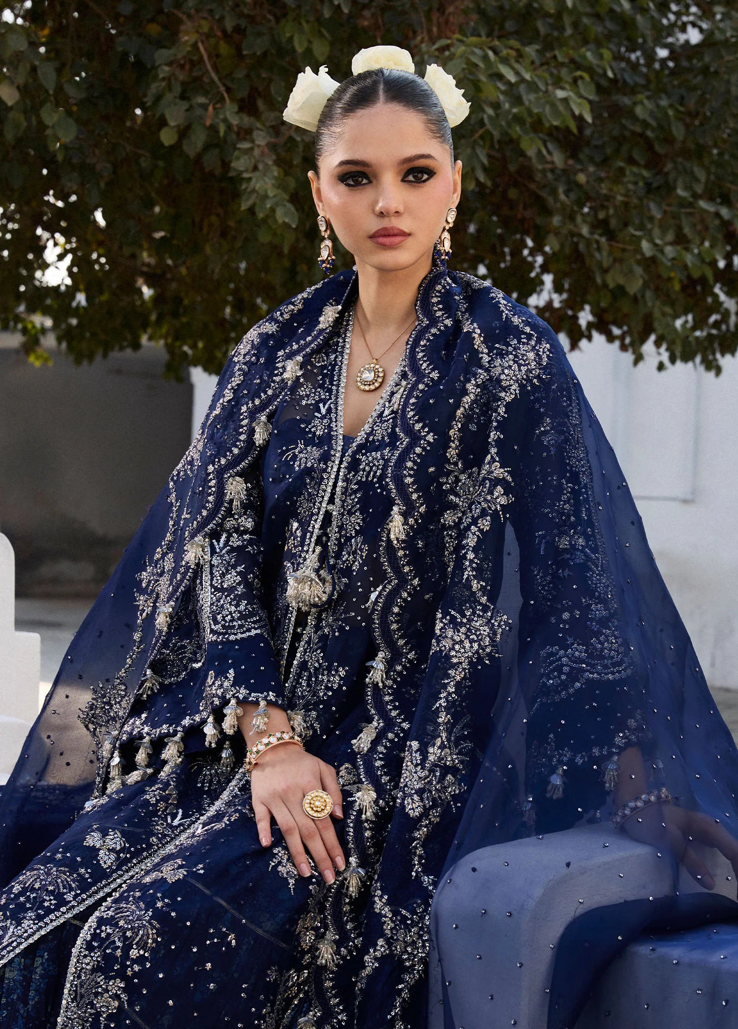 Model wearing Hussain Rehar Safa navy blue embroidered festive dress with intricate embellishments and sheer details. Shop Pakistani clothes online in the UK now.