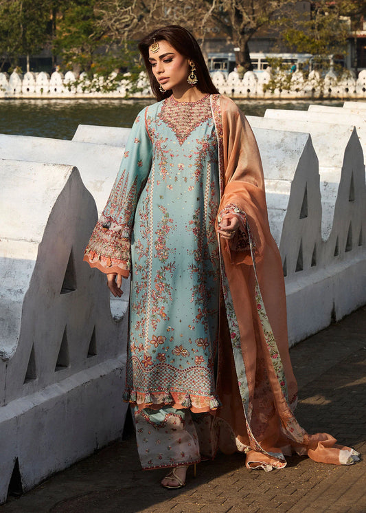 Model wearing Hussain Rehar Luxury Lawn '25 Malibu in turquoise blue with peach dupatta, intricate embroidery. Shop Pakistani luxury pret online in the UK.