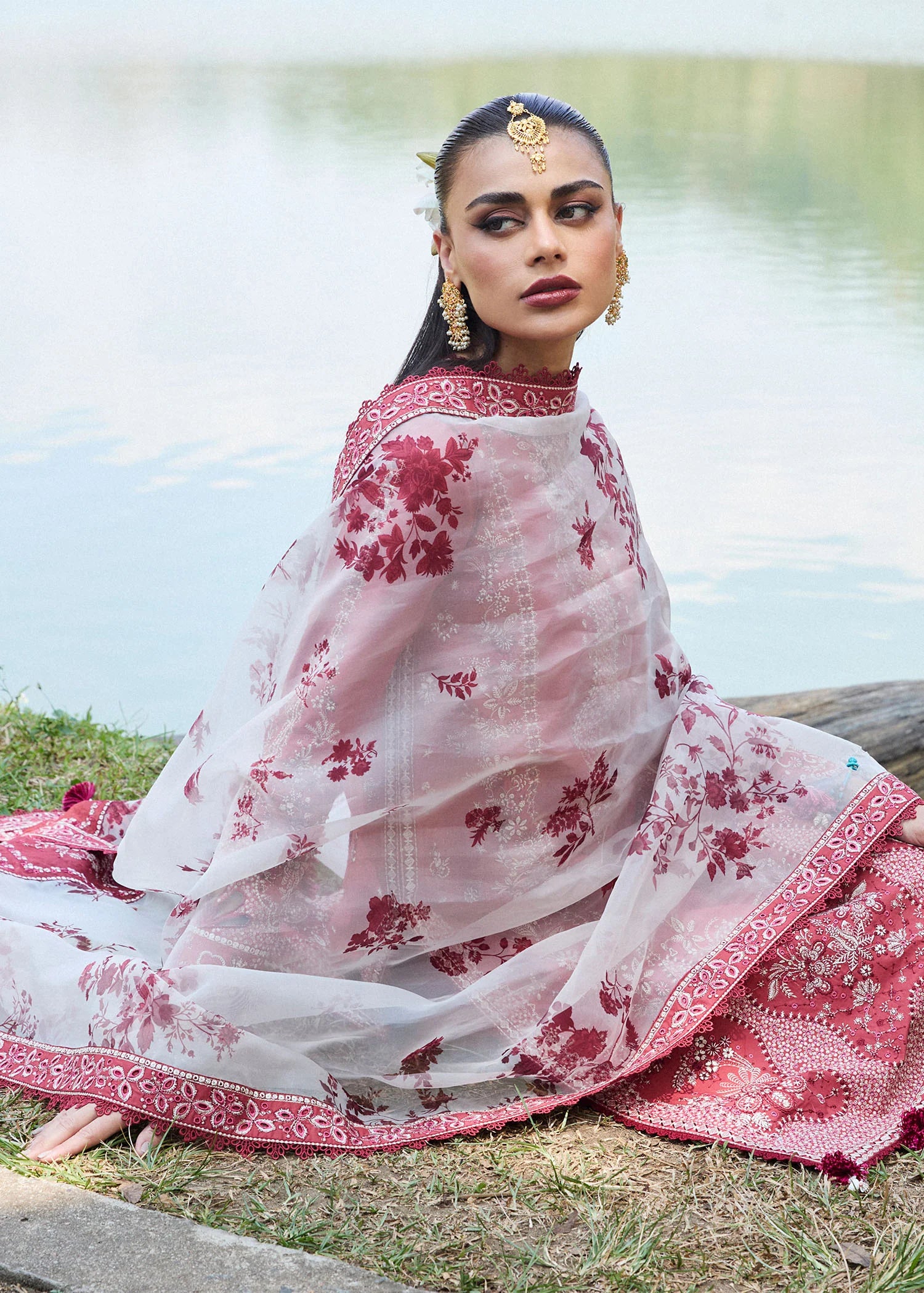 Model wearing Hussain Rehar Luxury Lawn '25 Flare in dark coral with intricate embroidery. Shop Pakistani luxury pret online in the UK.