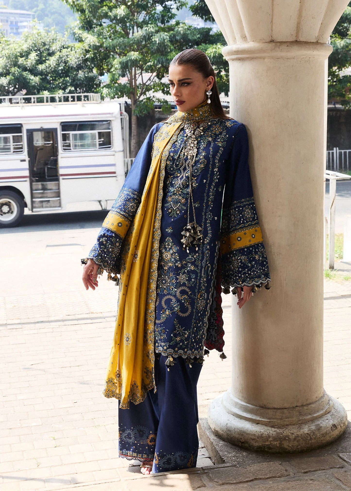 Model wearing Hussain Rehar Luxury Lawn '25 Riviera in royal blue with mustard dupatta, intricate embroidery. Shop Pakistani luxury pret online in the UK.