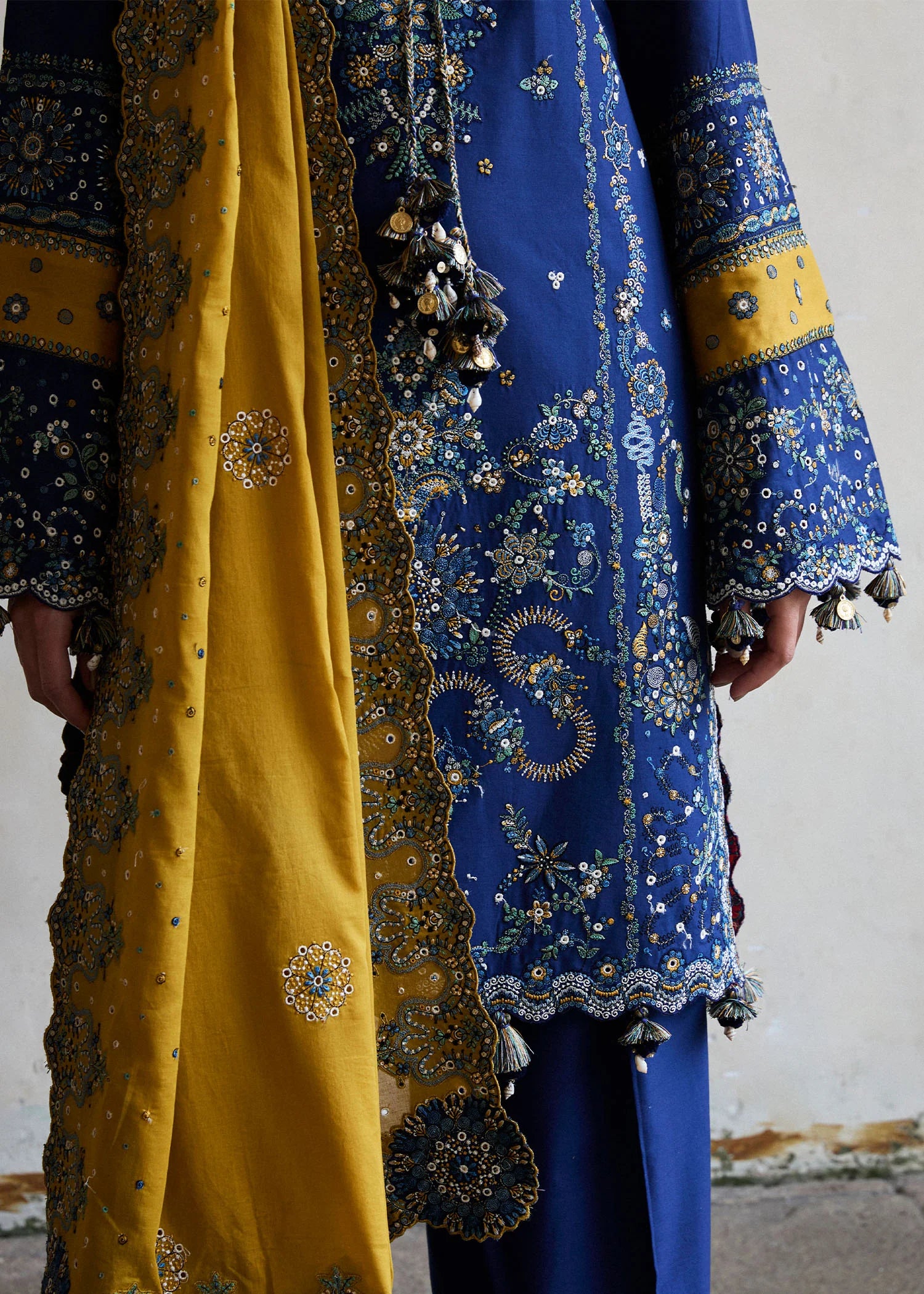 Model wearing Hussain Rehar Luxury Lawn '25 Riviera in royal blue with mustard dupatta, intricate embroidery. Shop Pakistani luxury pret online in the UK.