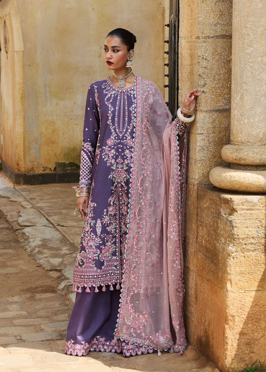 Model wearing Hussain Rehar Luxury Lawn '25 Irris in deep purple with intricate pink embroidery. Shop Pakistani luxury pret online in the UK.