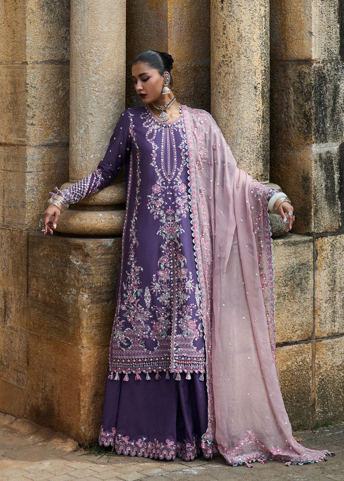 Model wearing Hussain Rehar Luxury Lawn '25 Irris in deep purple with intricate pink embroidery. Shop Pakistani luxury pret online in the UK.