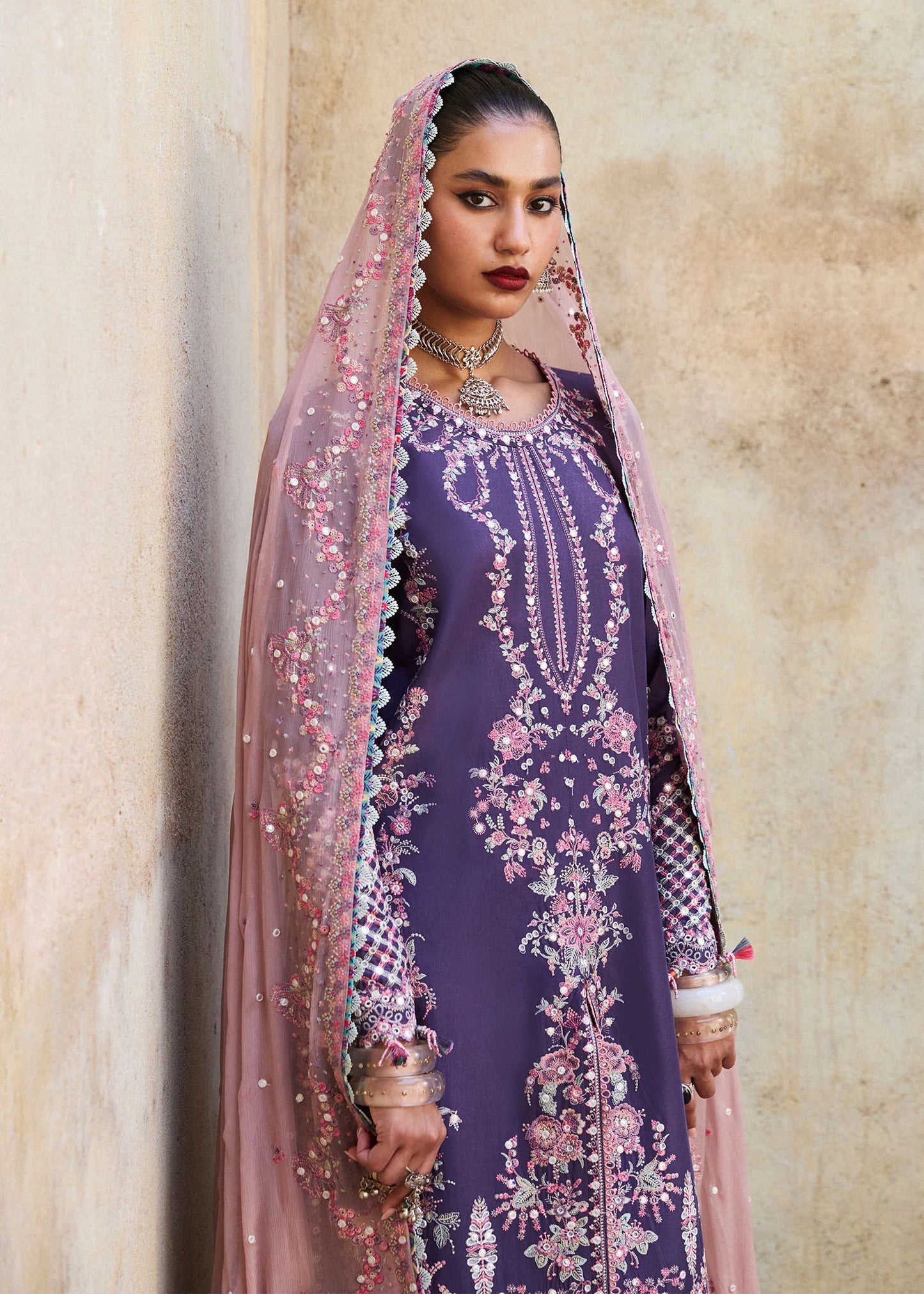 Model wearing Hussain Rehar Luxury Lawn '25 Irris in deep purple with intricate pink embroidery. Shop Pakistani luxury pret online in the UK.