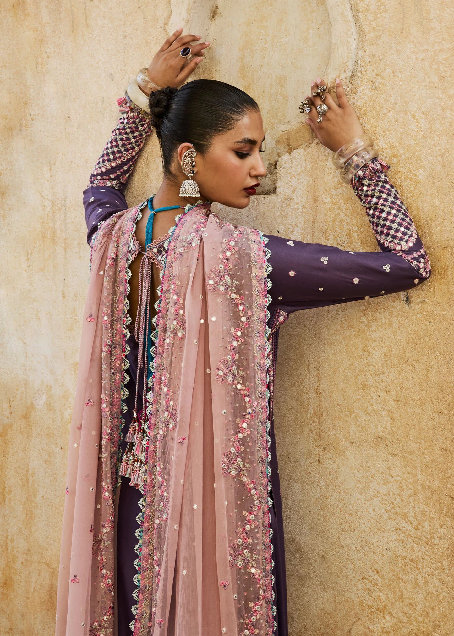 Model wearing Hussain Rehar Luxury Lawn '25 Irris in deep purple with intricate pink embroidery. Shop Pakistani luxury pret online in the UK.