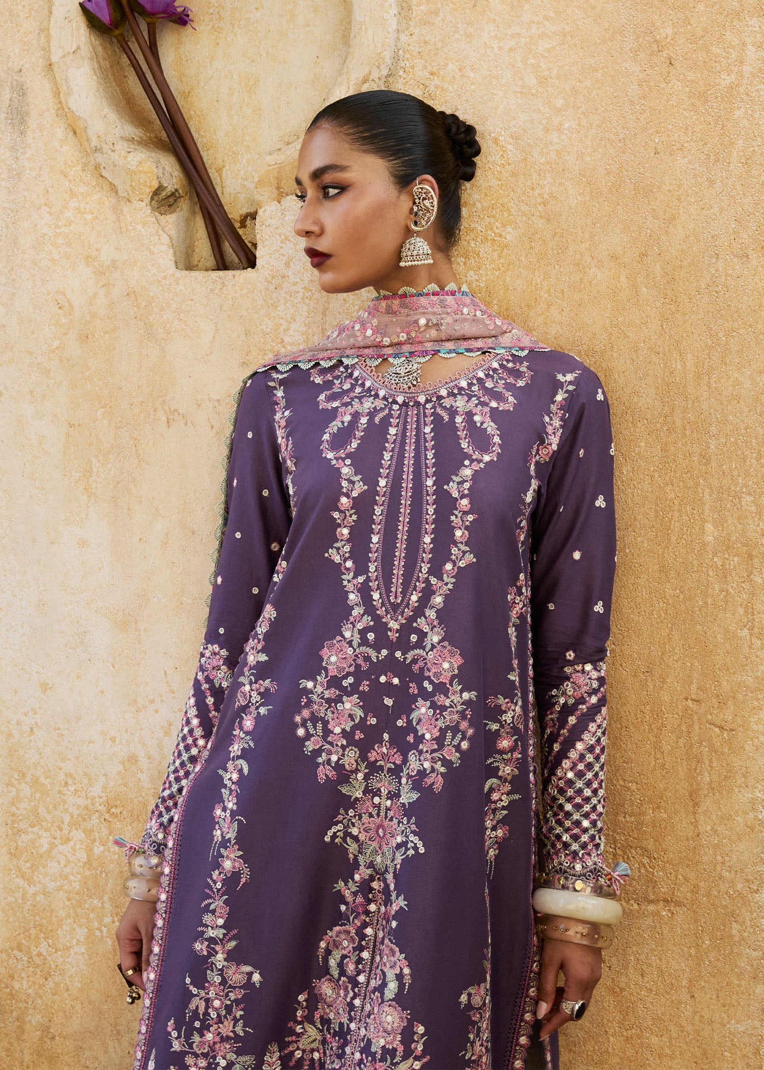 Model wearing Hussain Rehar Luxury Lawn '25 Irris in deep purple with intricate pink embroidery. Shop Pakistani luxury pret online in the UK.