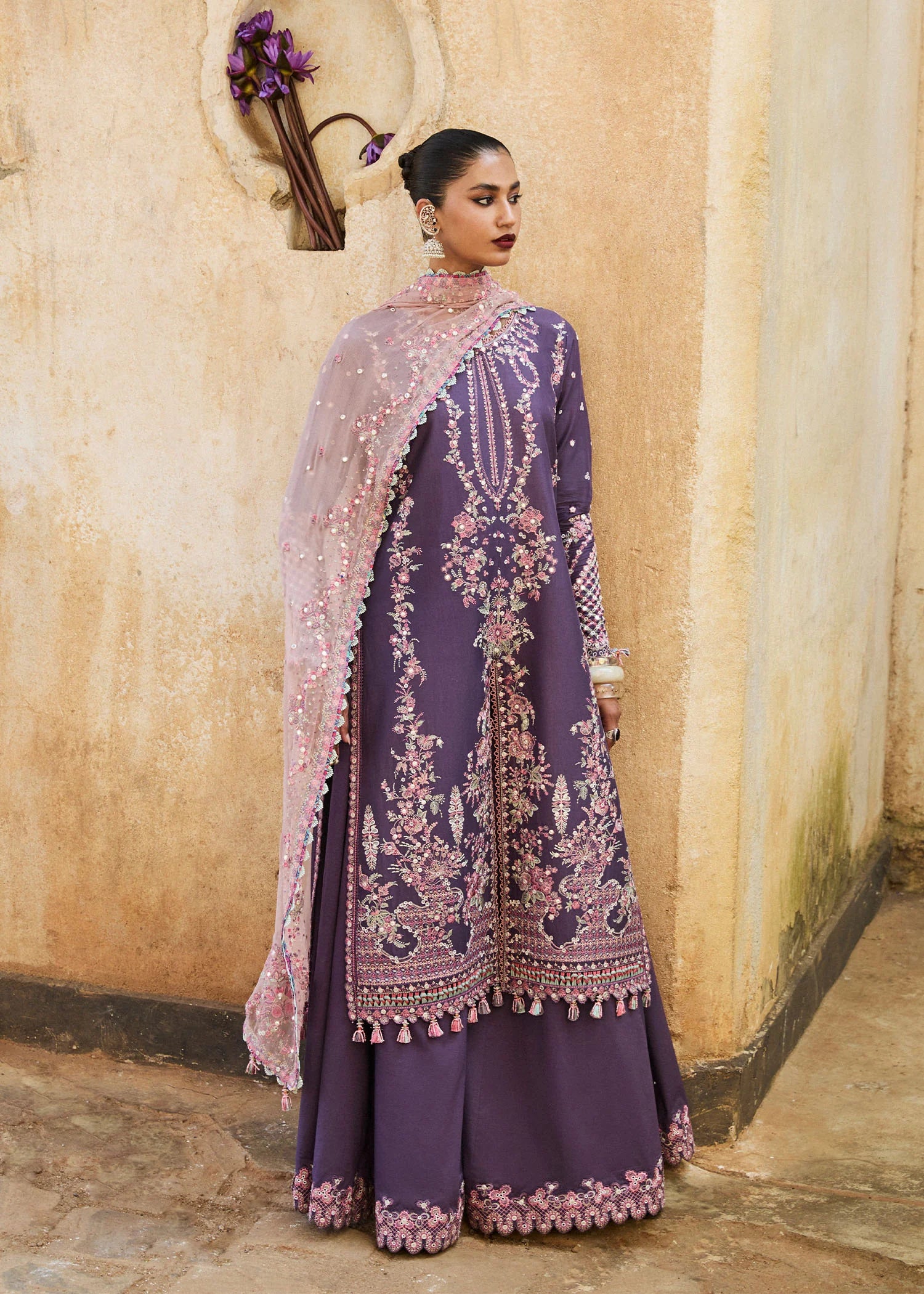 Model wearing Hussain Rehar Luxury Lawn '25 Irris in deep purple with intricate pink embroidery. Shop Pakistani luxury pret online in the UK.