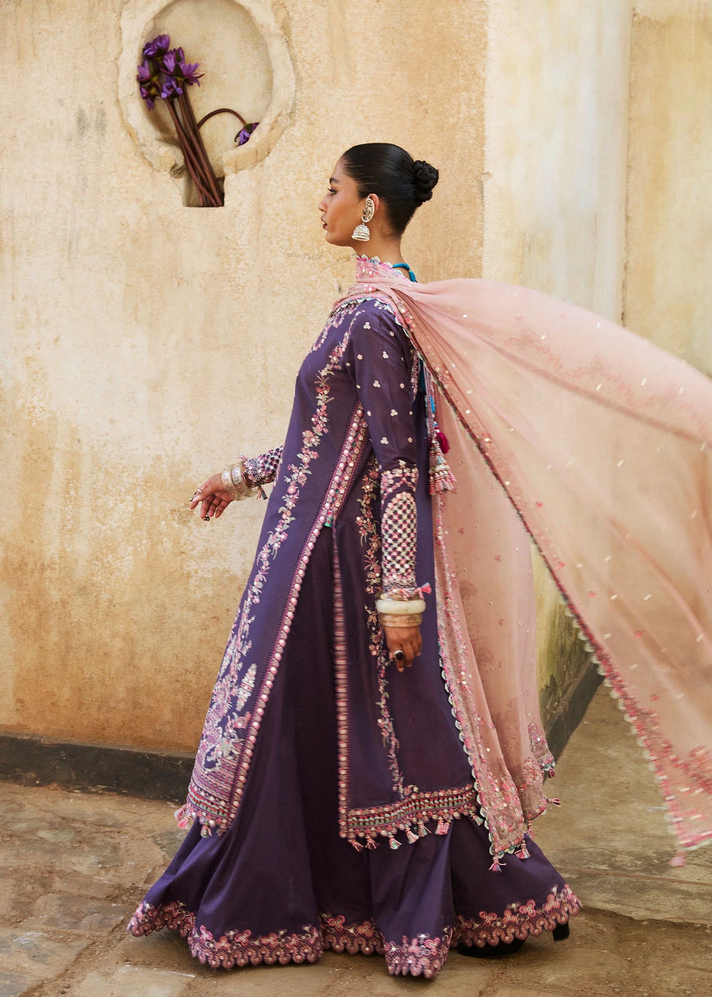 Model wearing Hussain Rehar Luxury Lawn '25 Irris in deep purple with intricate pink embroidery. Shop Pakistani luxury pret online in the UK.