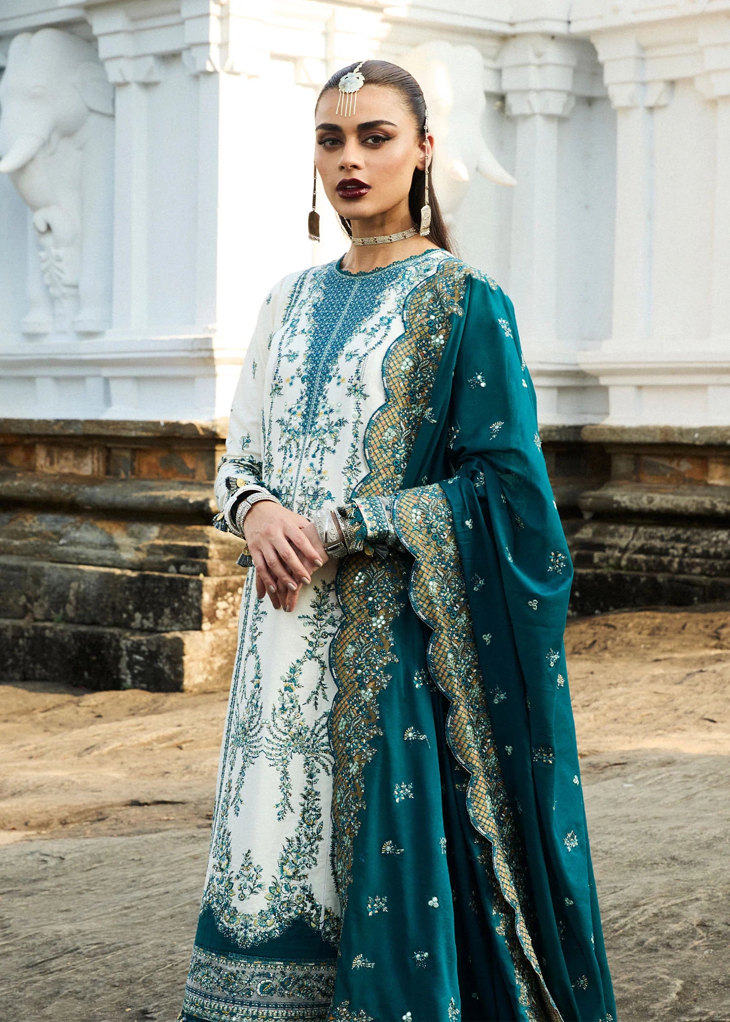 Model wearing Hussain Rehar Luxury Lawn '25 Veil in ivory with teal embroidery. Shop Pakistani luxury pret online in the UK.