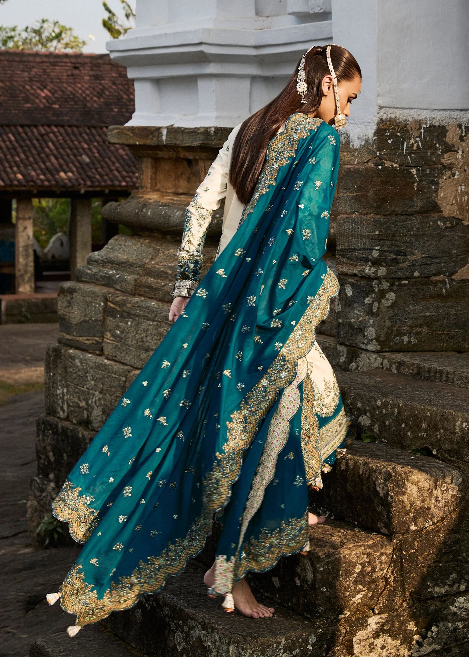 Model wearing Hussain Rehar Luxury Lawn '25 Veil in ivory with teal embroidery. Shop Pakistani luxury pret online in the UK.