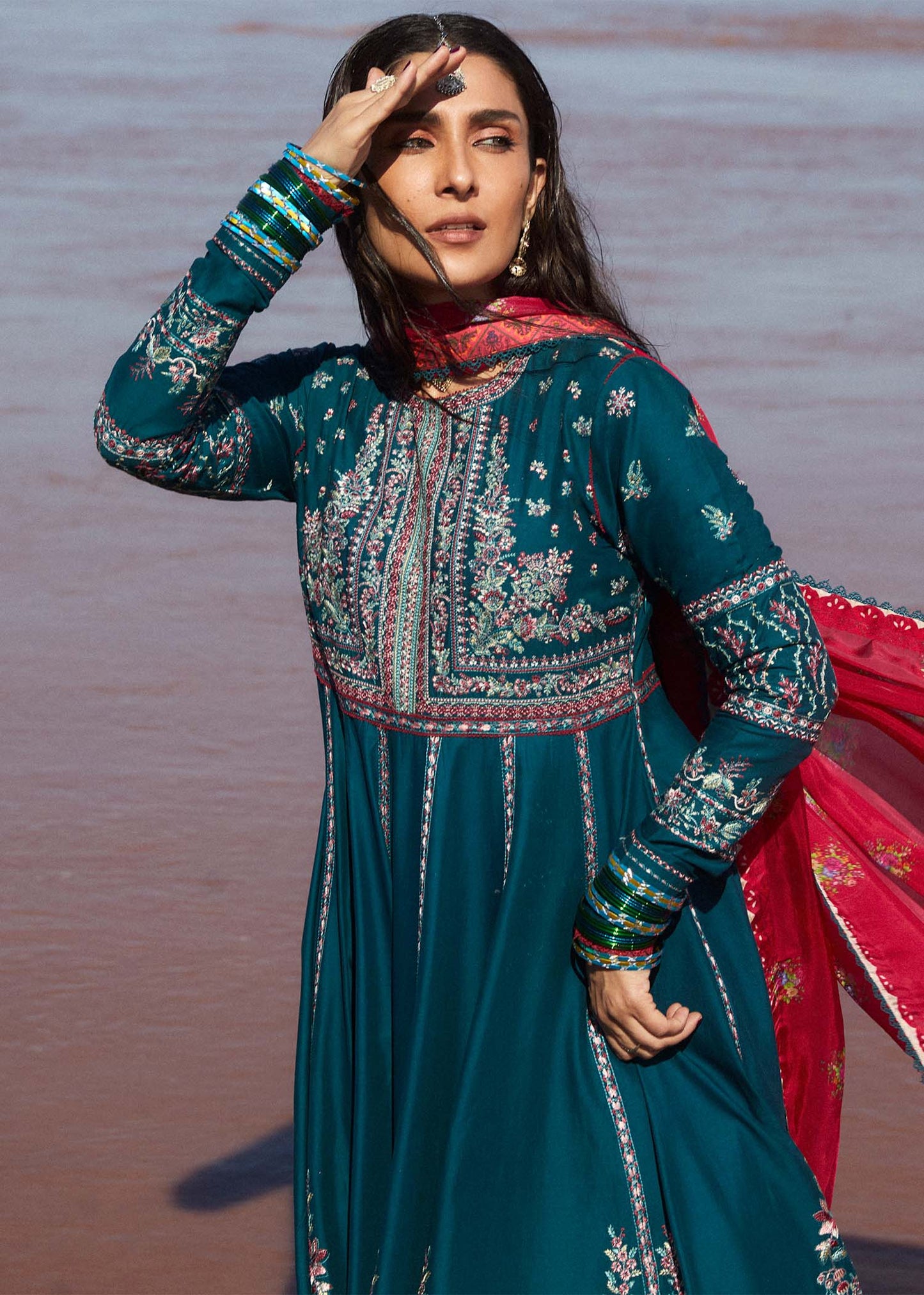 Model wearing teal Zarqash dress from Hussain Rehar with red dupatta, showcasing Pakistani luxury pret and Pakistani clothes online in UK.