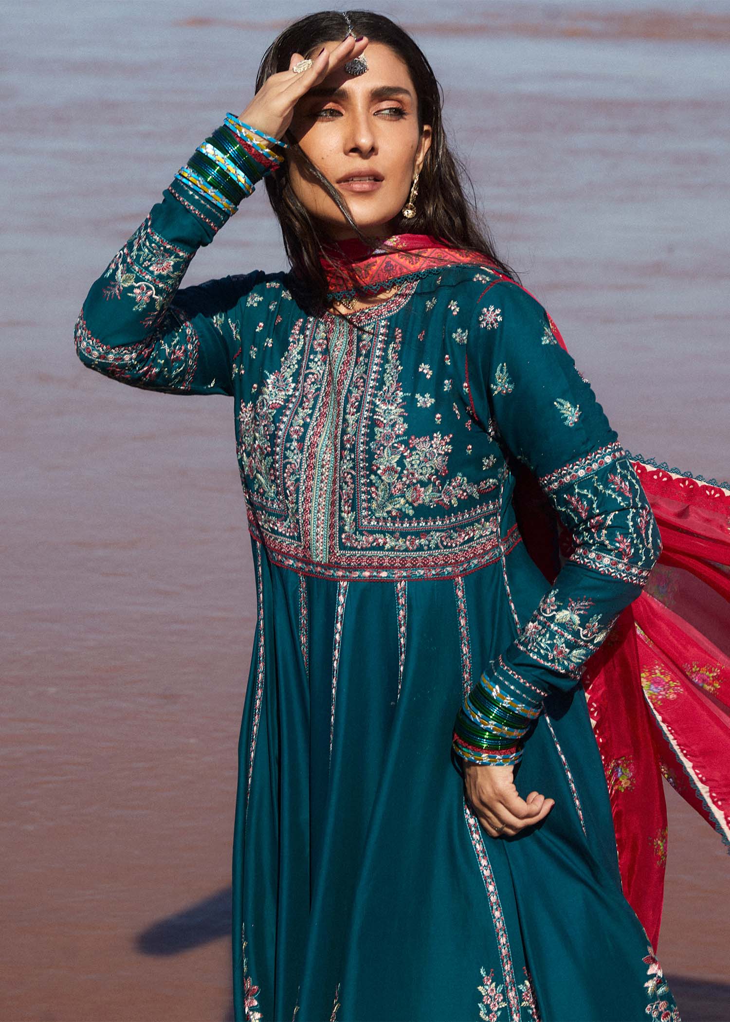 Model wearing teal Zarqash dress from Hussain Rehar with red dupatta, showcasing Pakistani luxury pret and Pakistani clothes online in UK.