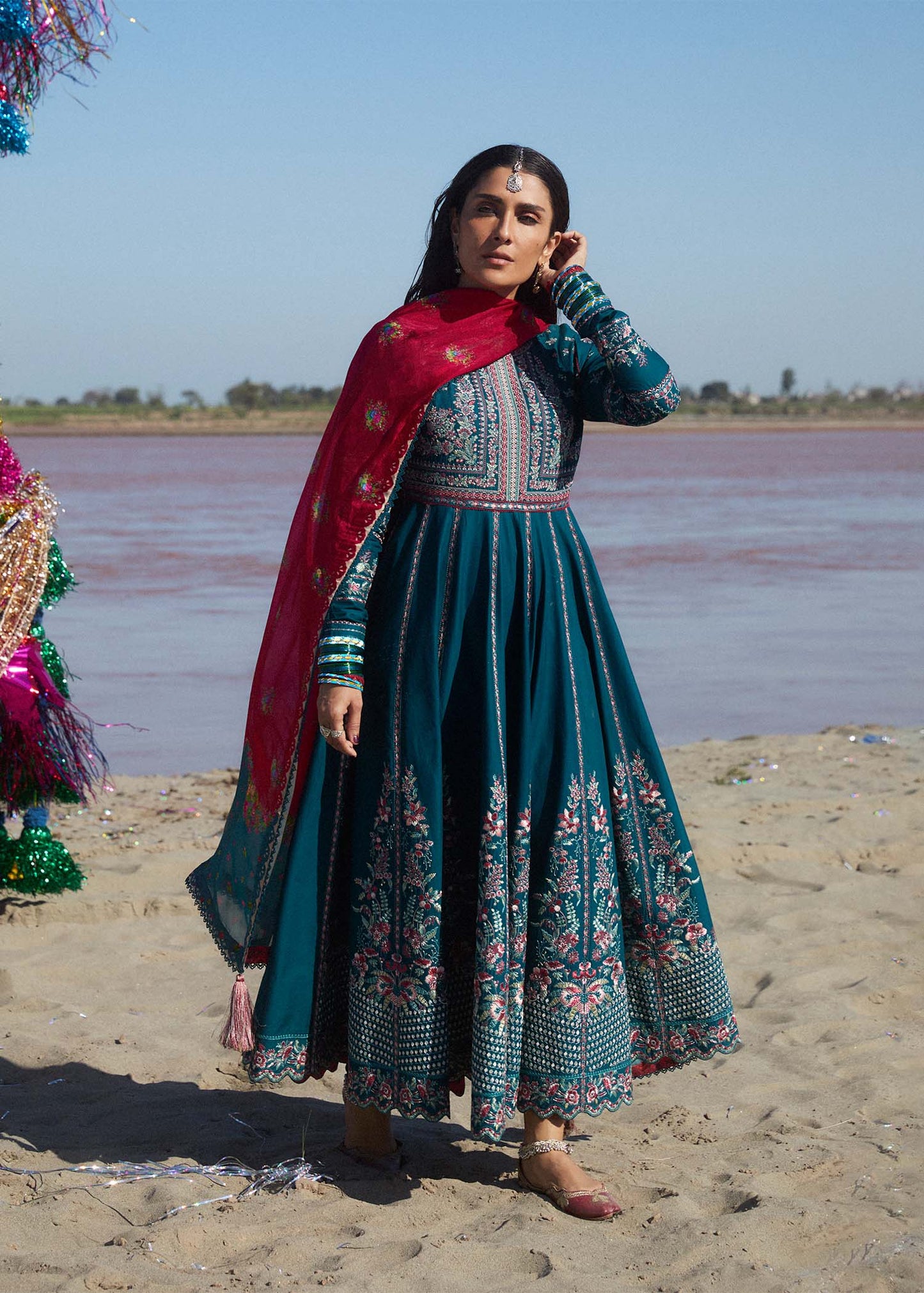 Model wearing teal Zarqash dress from Hussain Rehar with red dupatta, showcasing Pakistani luxury pret and Pakistani clothes online in UK.