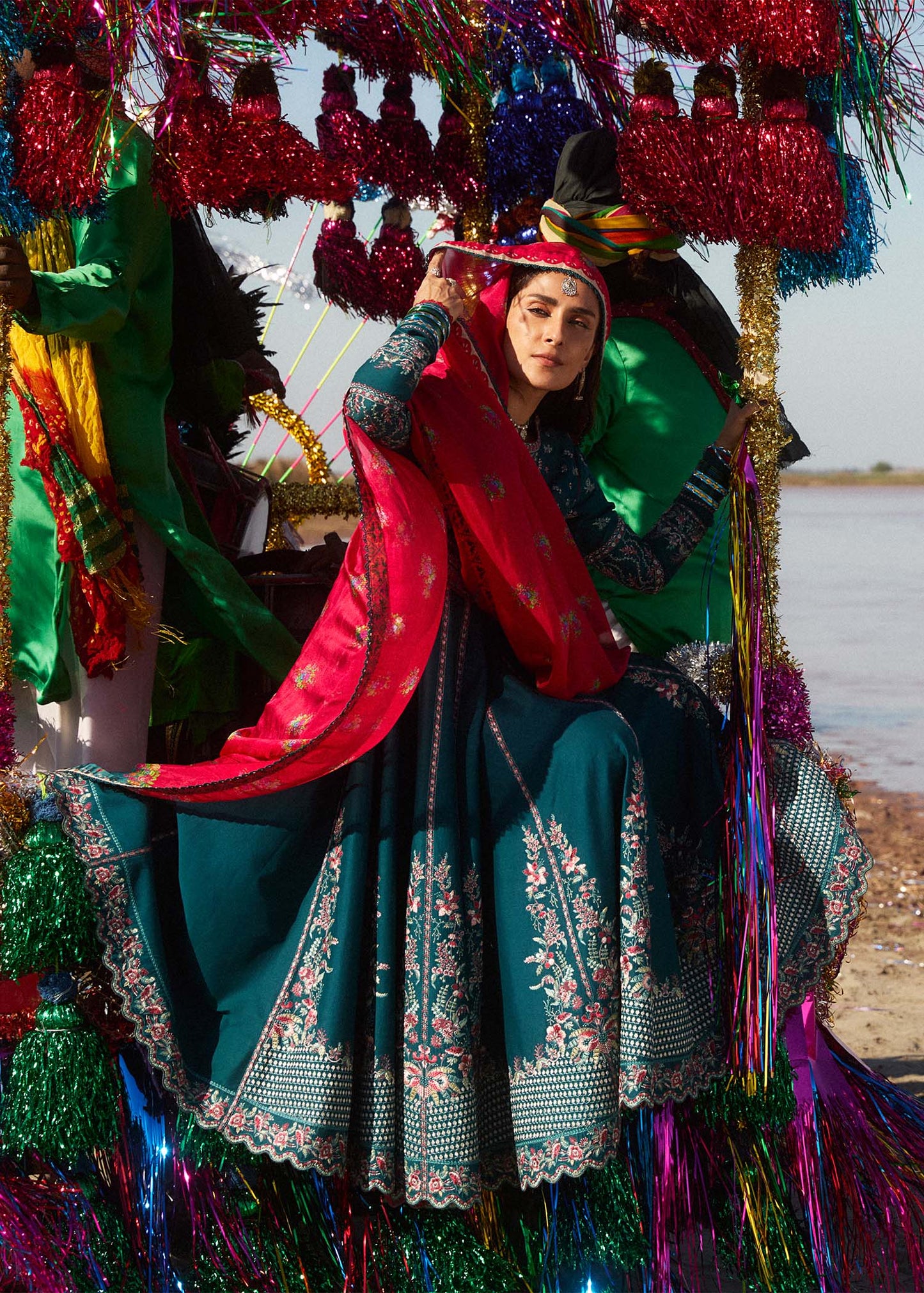 Model wearing teal Zarqash dress from Hussain Rehar with red dupatta, showcasing Pakistani luxury pret and Pakistani clothes online in UK.