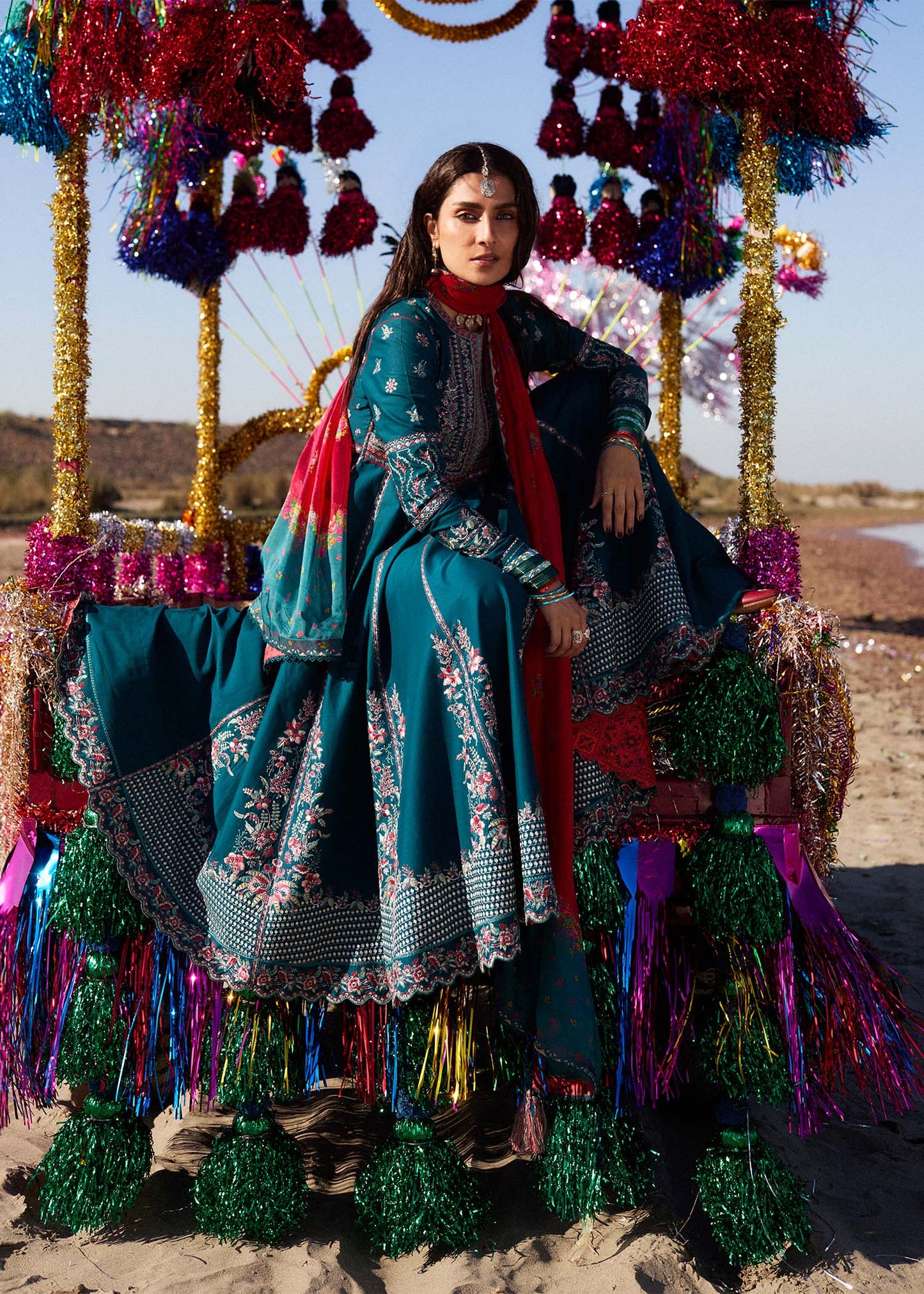Model wearing teal Zarqash dress from Hussain Rehar with red dupatta, showcasing Pakistani luxury pret and Pakistani clothes online in UK.