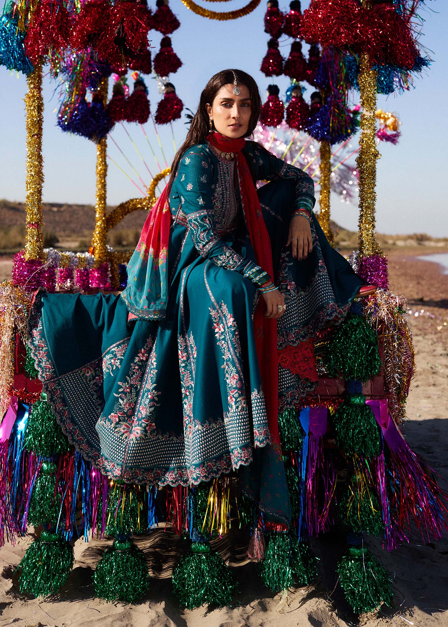Model wearing teal Zarqash dress from Hussain Rehar with red dupatta, showcasing Pakistani luxury pret and Pakistani clothes online in UK.