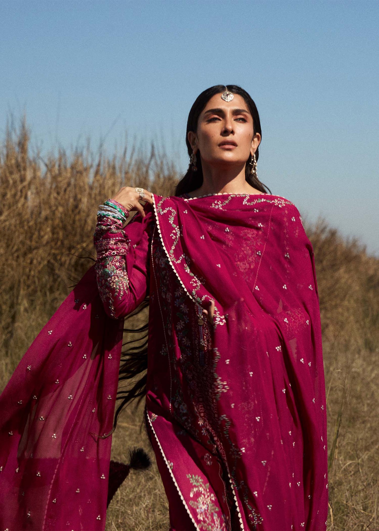 Model wearing deep pink embroidered dress Mehrunisa by Hussain Rehar, Pakistani luxury pret online in UK.