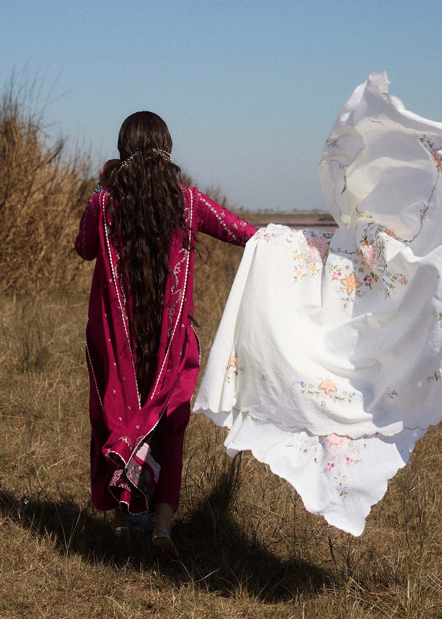 Model wearing deep pink embroidered dress Mehrunisa by Hussain Rehar, Pakistani luxury pret online in UK.