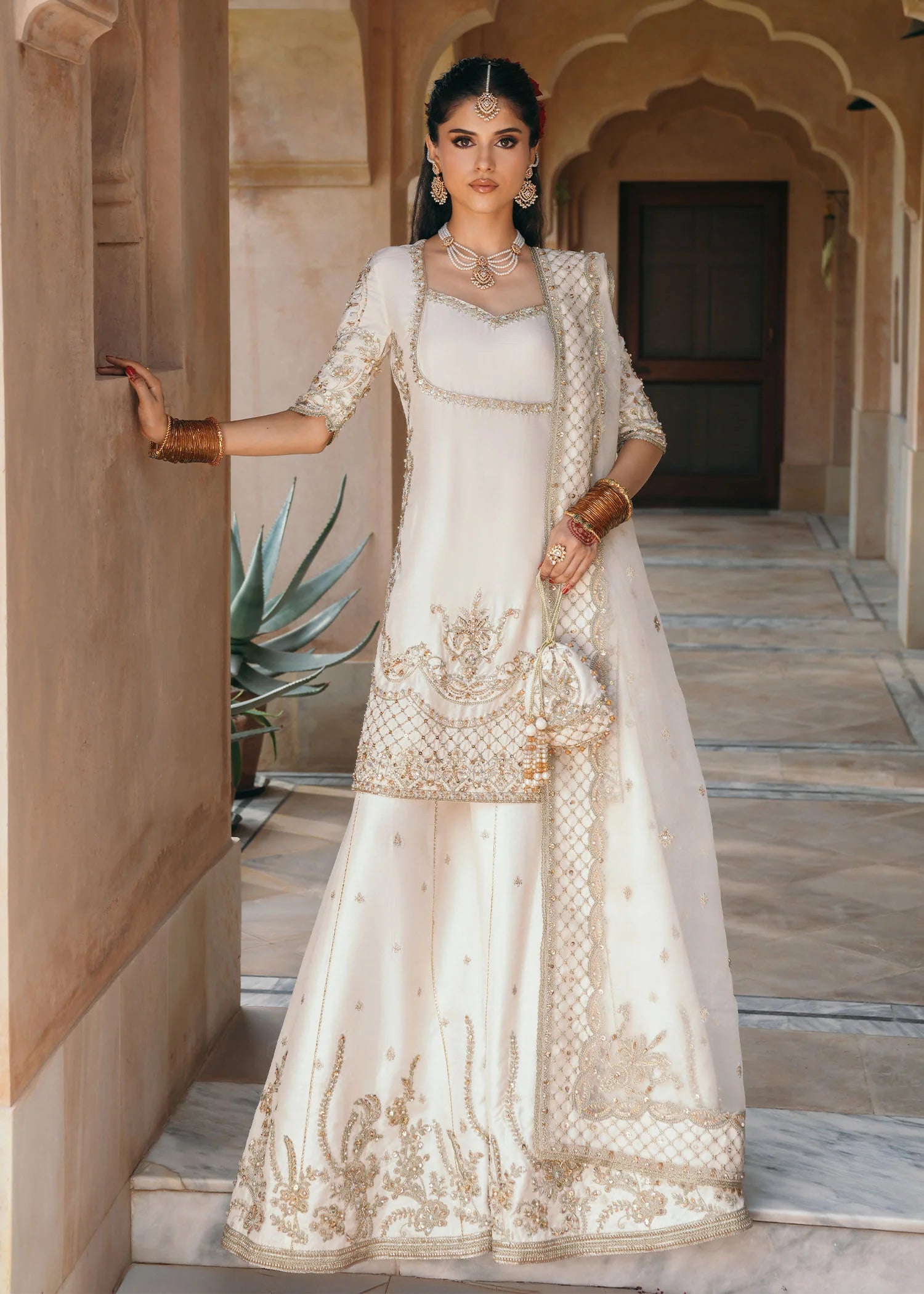 Model wearing Jaya by Kanwal Malik in ivory with gold embellishments – timeless Pakistani luxury pret outfit in UK.