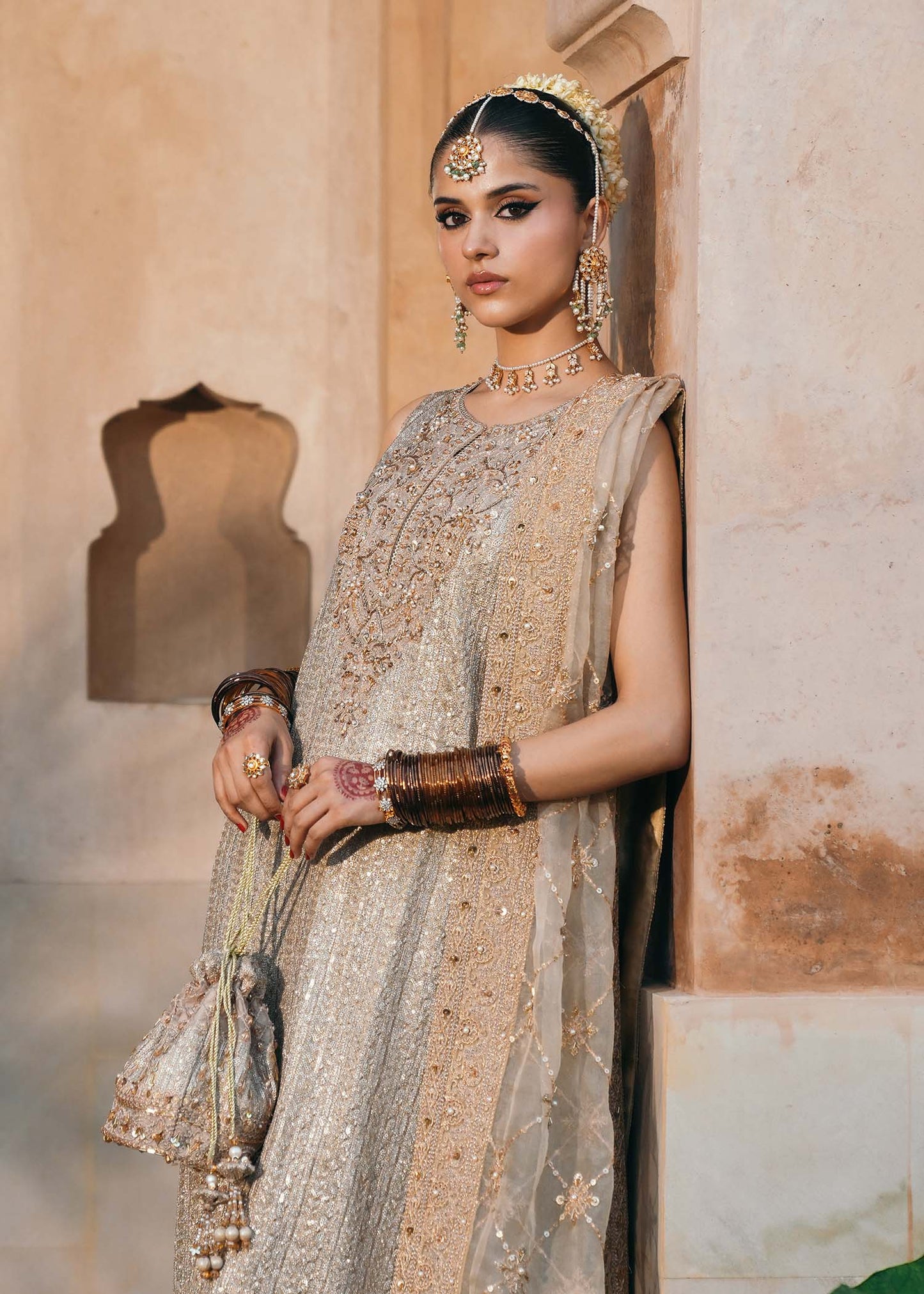 Model wearing Sitara by Kanwal Malik in champagne gold with intricate embellishments – stunning Pakistani luxury pret outfit in UK.