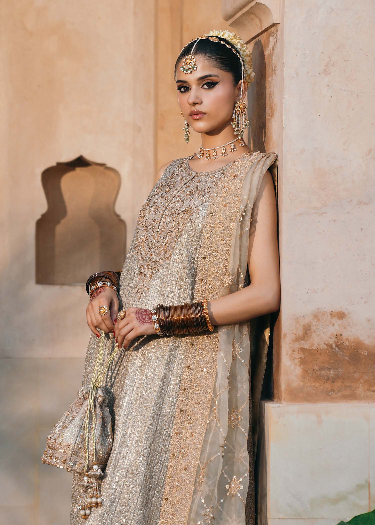 Model wearing Sitara by Kanwal Malik in champagne gold with intricate embellishments – stunning Pakistani luxury pret outfit in UK.