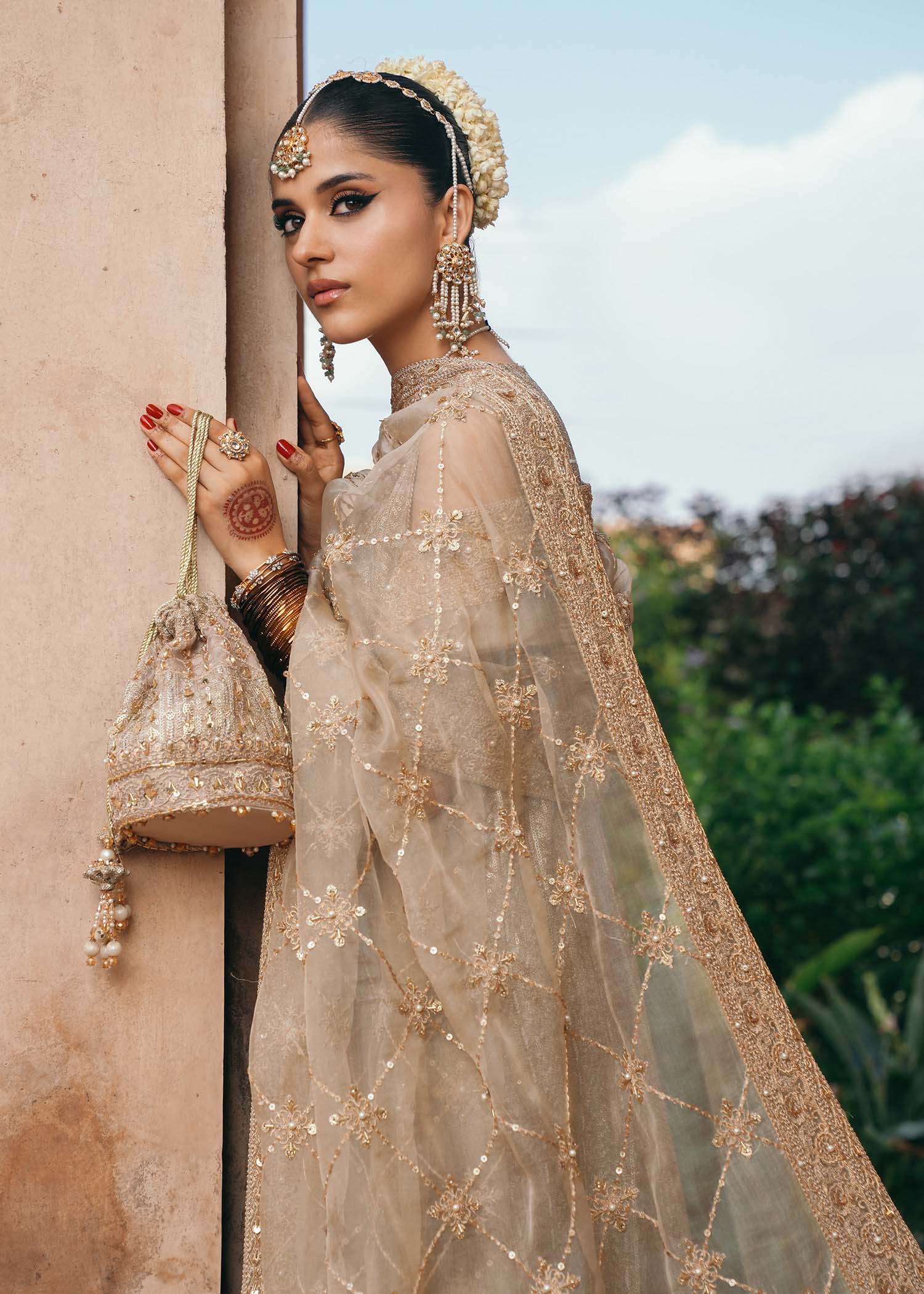 Model wearing Sitara by Kanwal Malik in champagne gold with intricate embellishments – stunning Pakistani luxury pret outfit in UK.