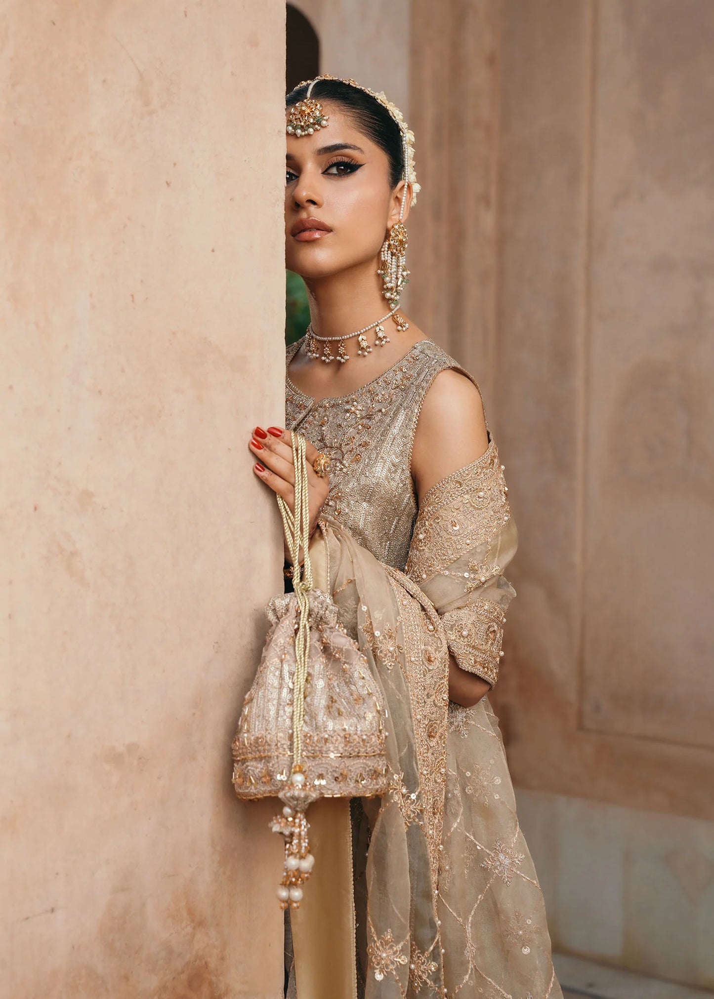 Model wearing Sitara by Kanwal Malik in champagne gold with intricate embellishments – stunning Pakistani luxury pret outfit in UK.